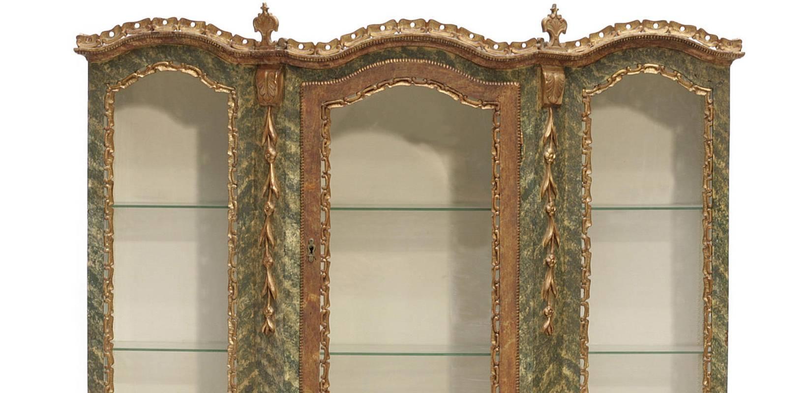 Beautiful 19th century Venetian Baroque style parcel-gilt and paint decorated breakfront display cabinet. Three glass doors over five drawers flanked by two painted doors. 

Including two glass shelves.