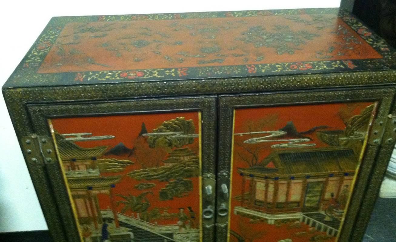 Attractive antique Chinese polychromed Coromandel and lacquered two-door cabinet with three interior long drawers, early 20th century.

  