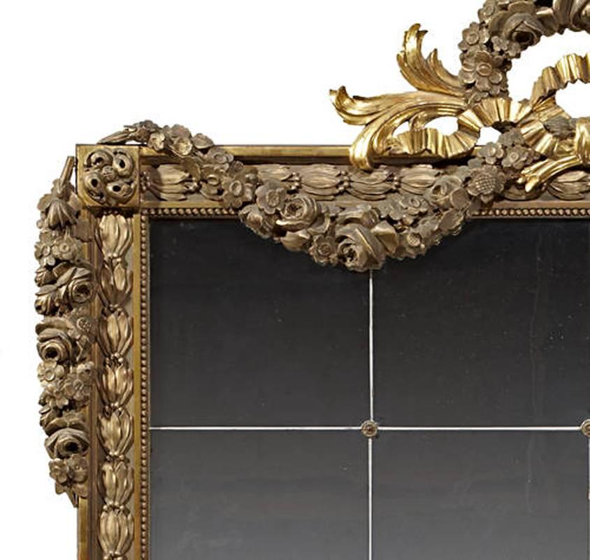 Incredible 19th century Italian neoclassical style gilded mirror, the finely carved swags with two tone gilding are over an intricate frame, crowned with a wreath, acanthus leaves and ribbon. 
The later mirror is sectioned by 12 square pieces
