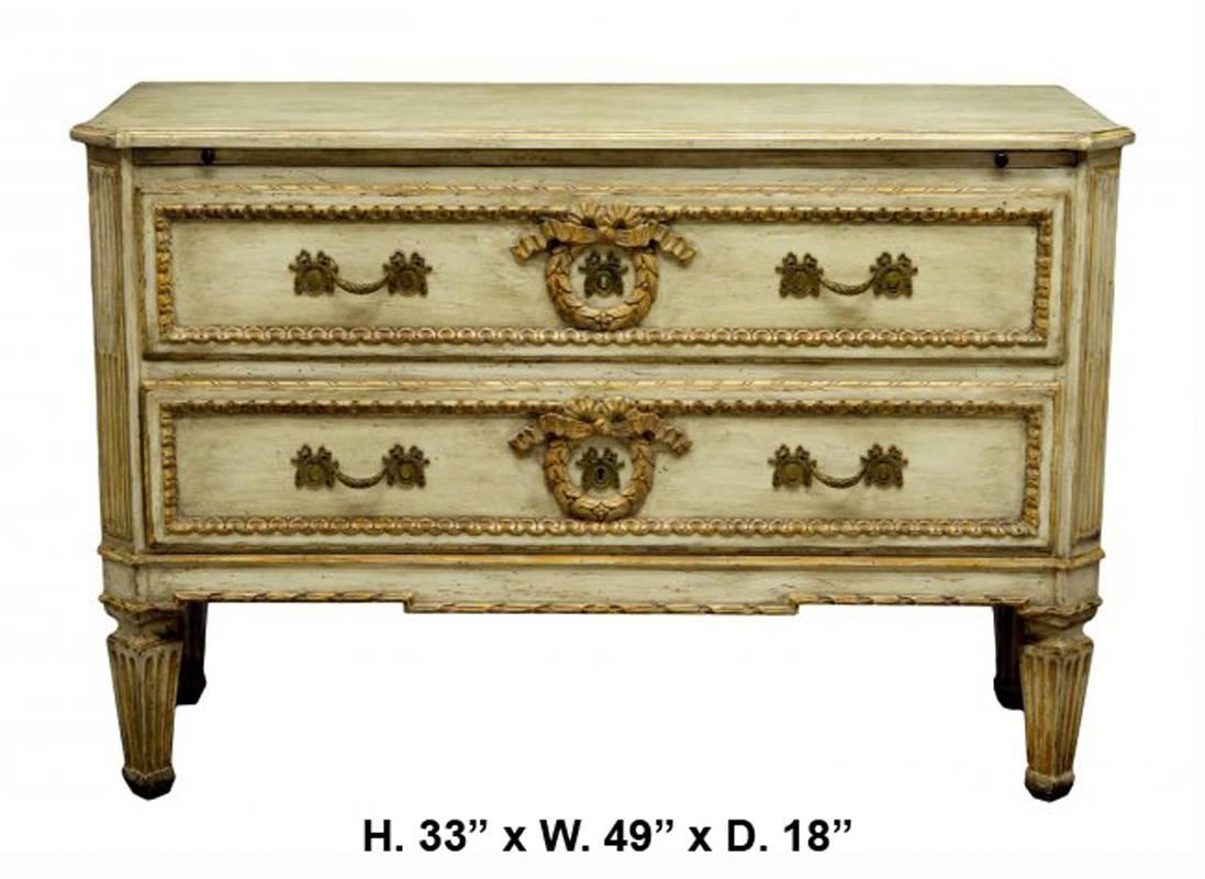 Attractive French neoclassical style Louis XVI style two-drawer commode. Rectangular beige painted wooden top over a writing slide and two large drawers with partial gilt centered by carved wreath, all on four fluted tapered legs, second half of the