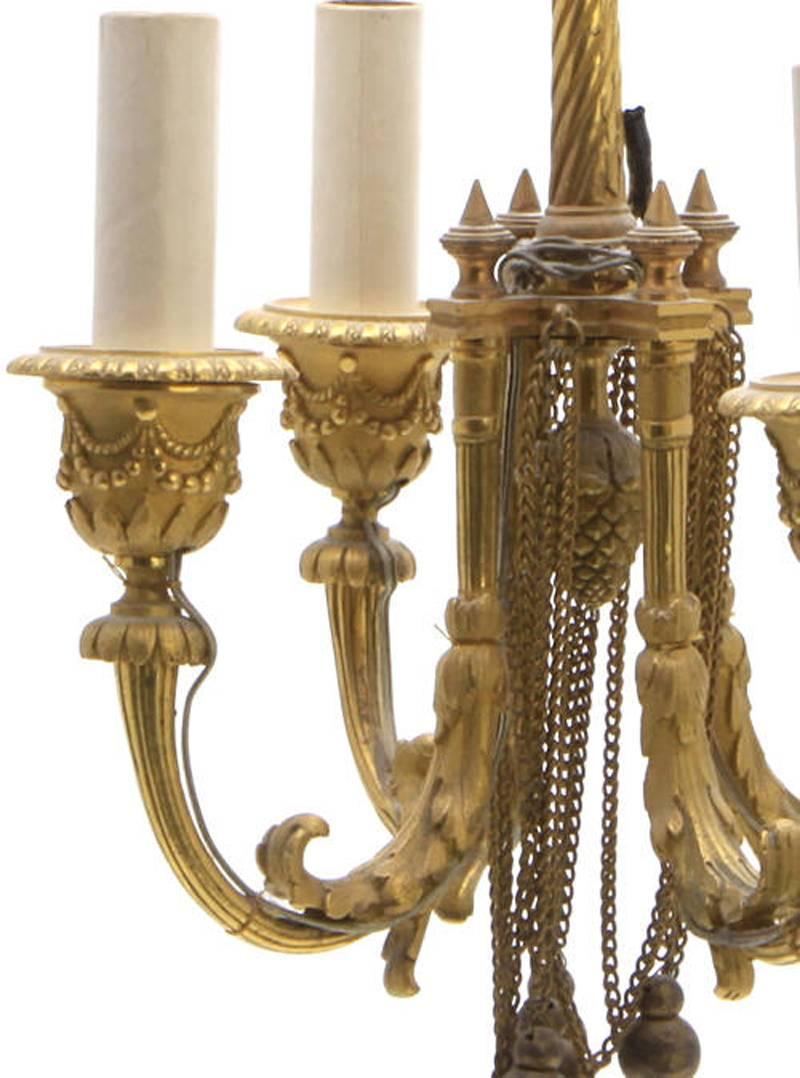 Extremely fine small Louis XVI style ormolu four-light chandelier form lantern.
The spiral standard issuing foliate decorated scroll arms supporting swag decorated candle cups.
