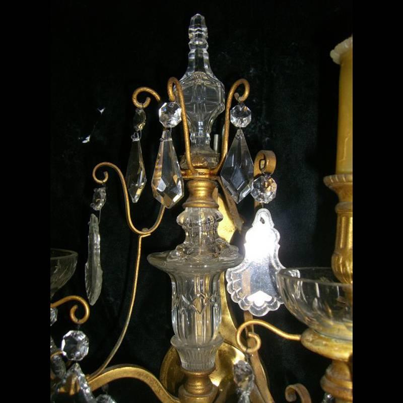 Unusual French pair of 19th century beautifully cut crystal ormolu-mounted two-light sconces with crystal urns in the center. 
Possibly Baccarat.