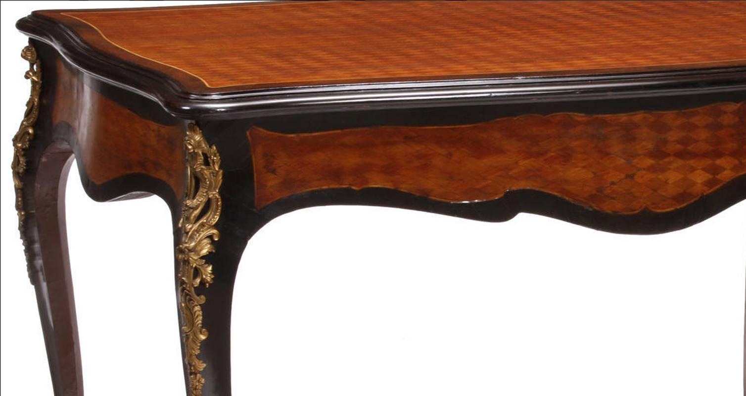 Elegant 19th century French Louis XV style parquetry inlaid kingwood and ebonized bureau plat with fine ormolu mounts. The parquetry top over long hidden drawer all on four cabriole legs mounted with Rocaille gilt bronze mounts and ormolu sabots.