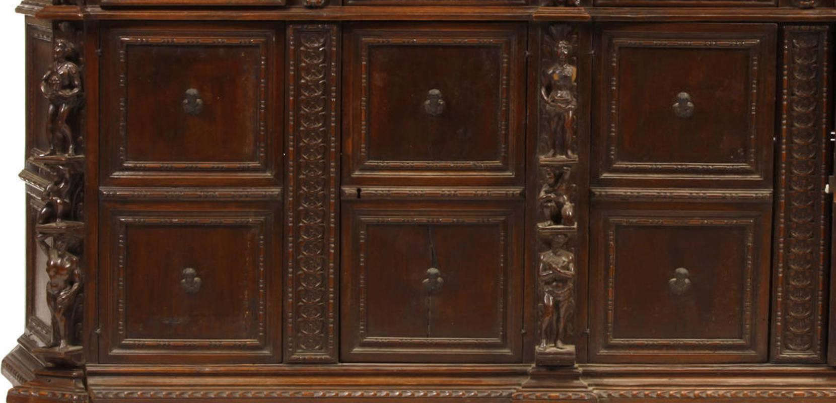 Magnificent 19th century Italian Renaissance style carved walnut long figural credenza. Solid walnut top over a frieze containing four drawers with wooden knobs over four doors flanked and centred by finely carved Renaissance figures, all supported