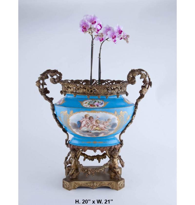Attractive late 19th century French gilt bronze-mounted Sèvres style porcelain oval centrepiece.
The Sèvres Porcelain centrepiece is centred by a hand-painted panel portraying a putti scene in the front and a floral still-life scene in the back