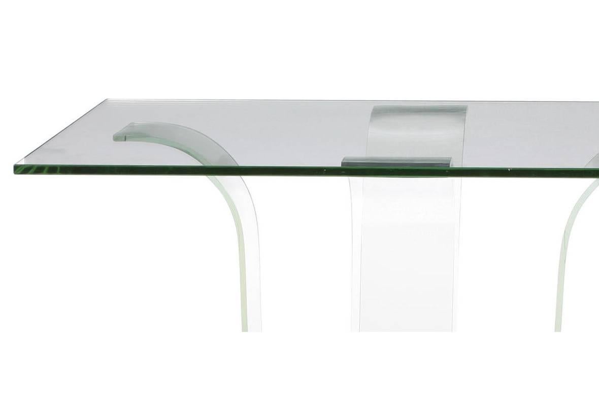 Contemporary glass and wood centre table. Thick glass top resting on four curved glass supports on wood plinth. 

Glass top thickness is 3/4 inch.