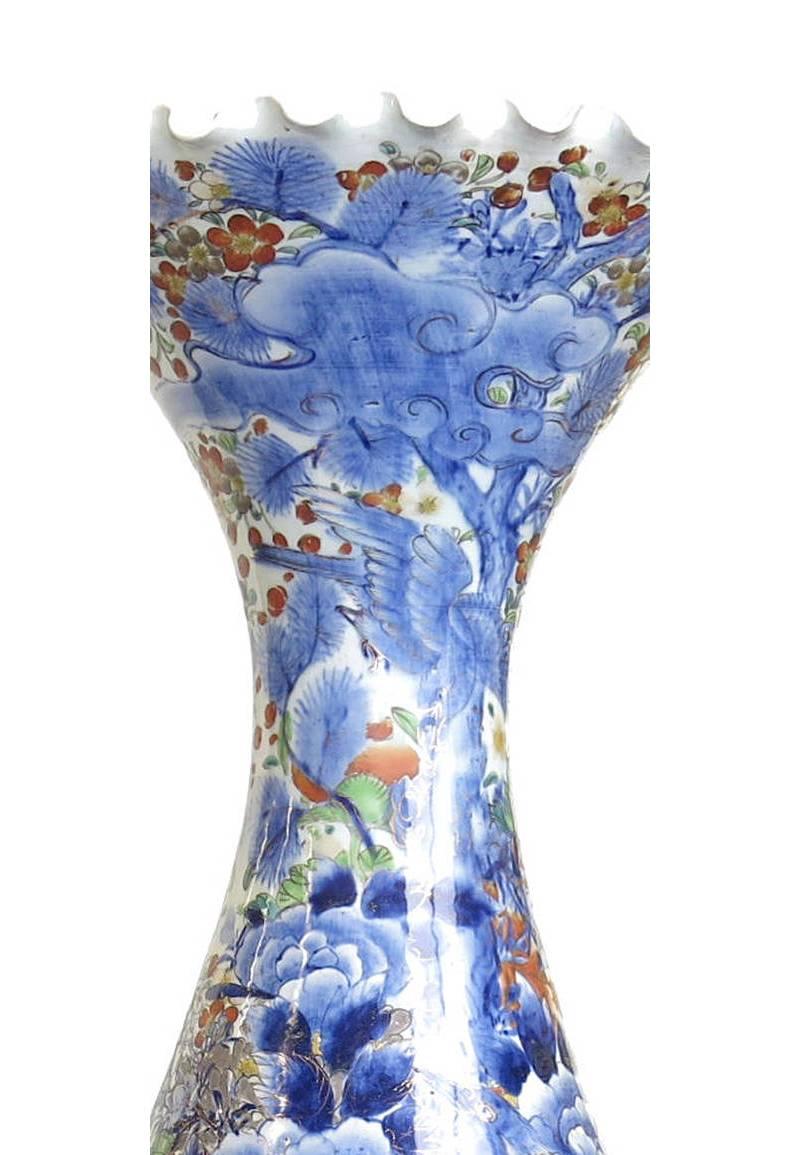 Beautiful Japanese Imari porcelain trumpet neck floor vase with striking blues and colorful floral and leaf motif. Meiji period.

 