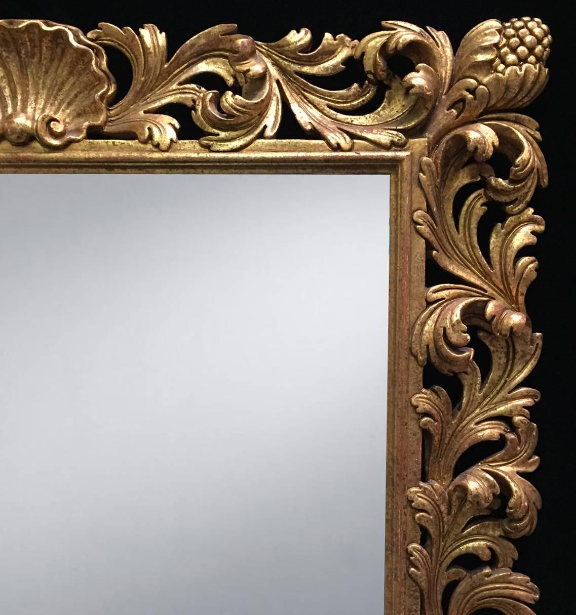 Attractive Roman Baroque style finely carved giltwood rectangular mirror with shell and acanthus leaf motif, circa 1900.

