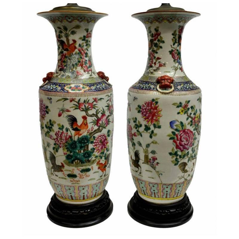 Attractive pair of large Chinese hand-painted vases mounted to lamps with rooster and floral motif on circular wooden bases, late 19th-early 20th century. 

Porcelain vase dimensions:
Height 23 inches x diameter 20 inches.

Overall height of
