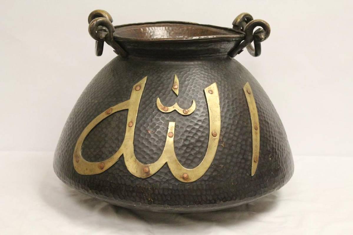Antique Middle Eastern hand-hammered bronze water jar with Middle Eastern Islamic inscription. 
Possibly 19th century.

 