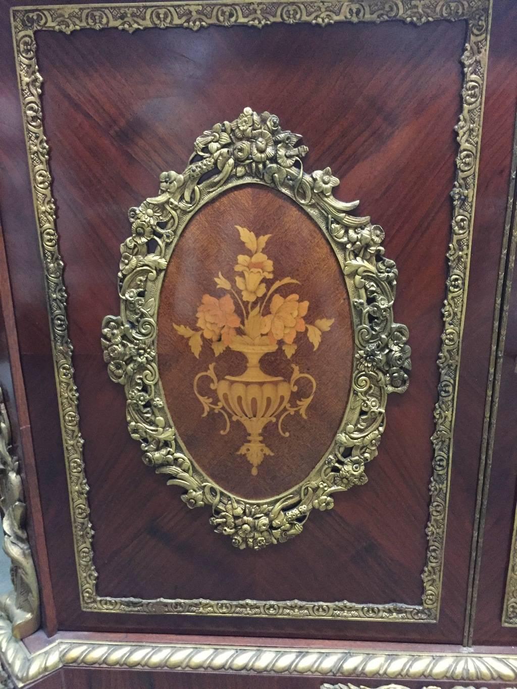 French ormolu-mounted marquetry two door credenza.
The marble top over a long drawer over two doors centered with oval medallion beautifully mounted with ormolu and fine inlay. Sides are mounted with further bronze mounts and inlay, all supported