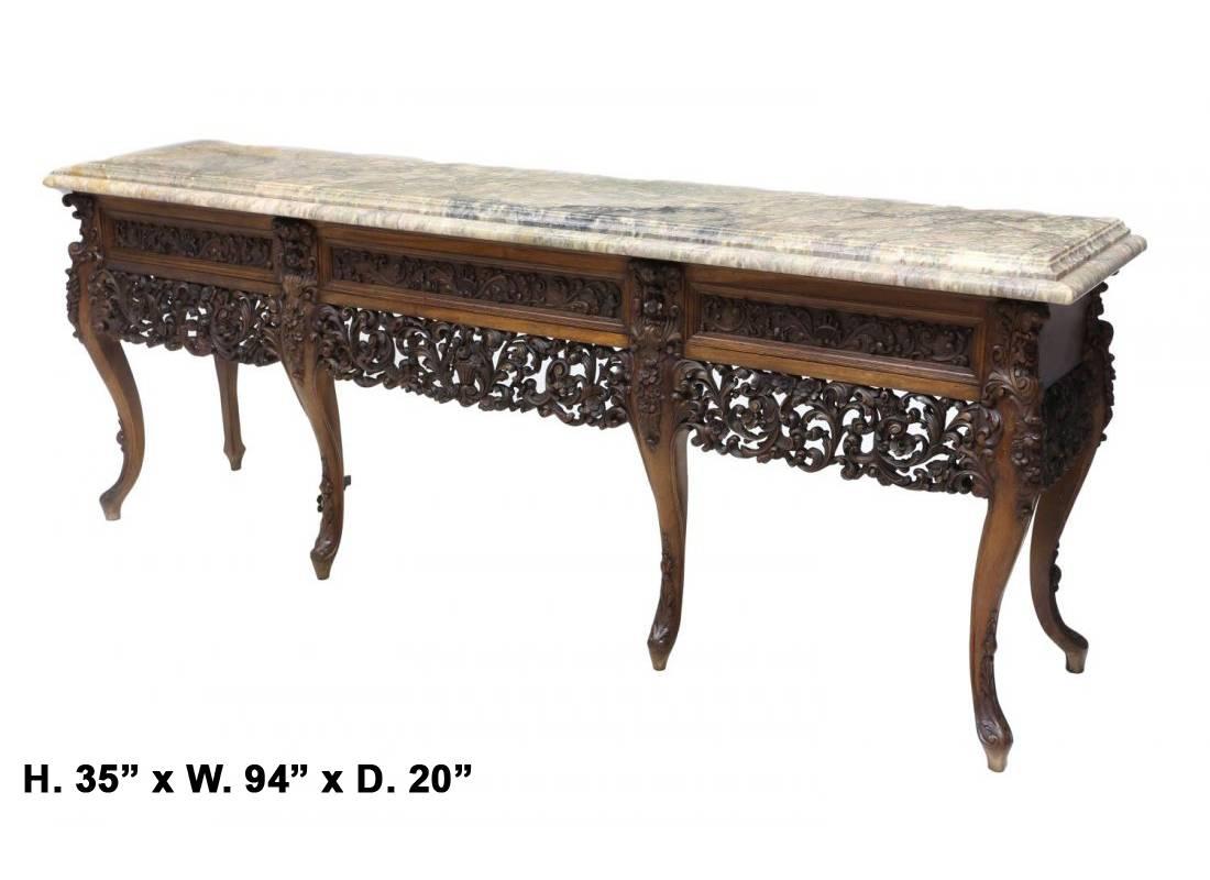 Unique and magnificent 19th century Spanish Baroque style carved walnut console with three drawers, the unusually thick marble top over an intricately carved frieze with acanthus and foliage motif, all on six cabriole legs.

 