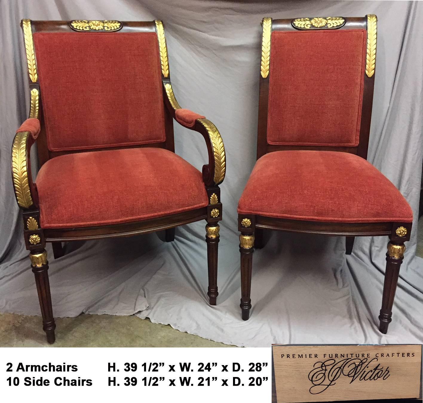 Spectacular set of 12 Regency style parcel-gilt mahogany dining chairs with gold leafed laurel leaves.
Handcrafted by E. J. Victor. 
  
Dimensions of the chairs:
Arm H 40