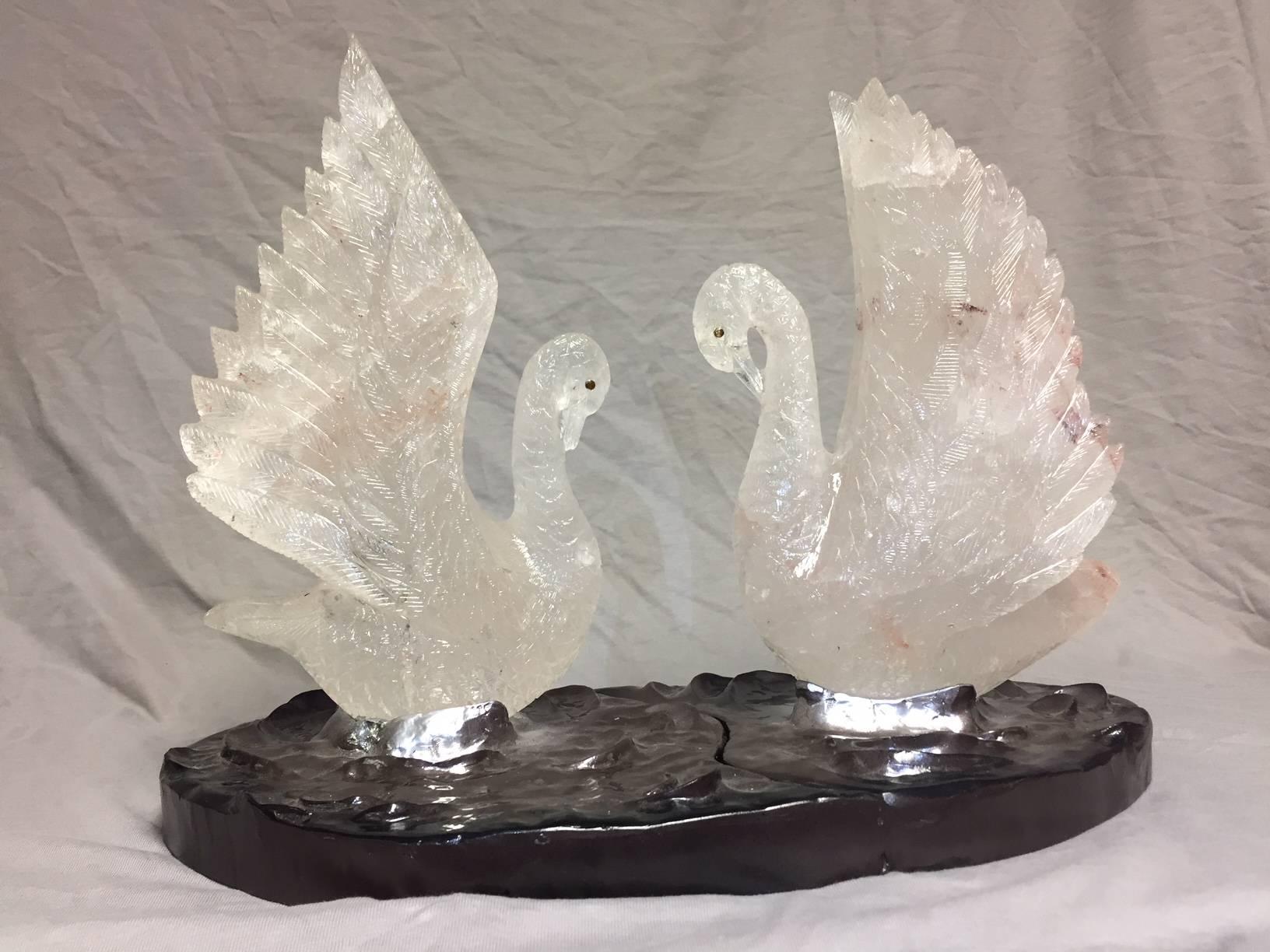 Imposing one of a kind modern style intricately fine hand-carved rock crystal swan group centrepiece in swimming motion on metal base portraying waves on a pond.