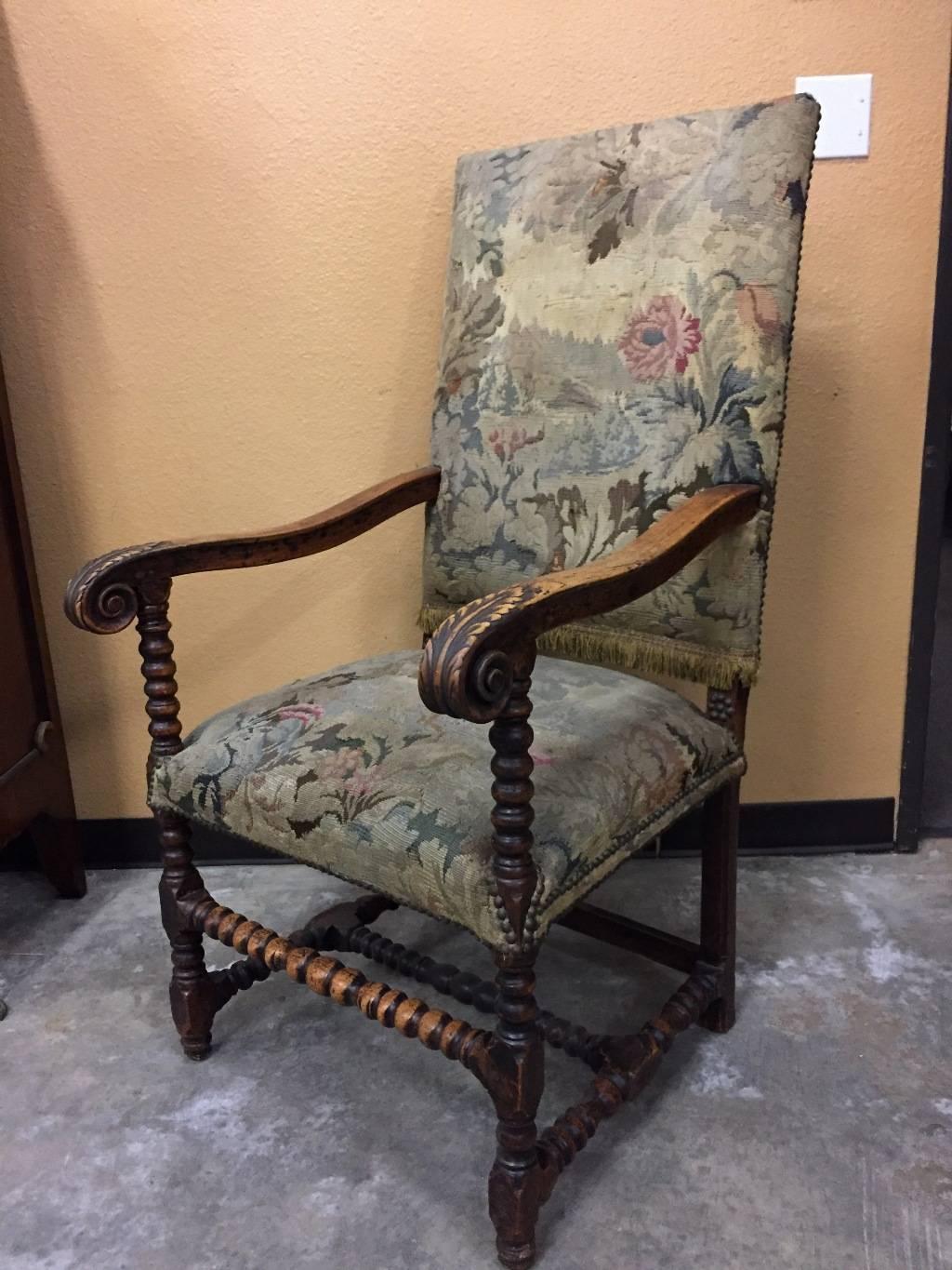 Magnificent 19th century Louis XIII style carved walnut armchair with scenic tapestry upholstery and acanthus leaf motif arms, terminating in turned legs conjoined by turned stretcher. 
The upholstery is a 19th century handmade Flemish tapestry.