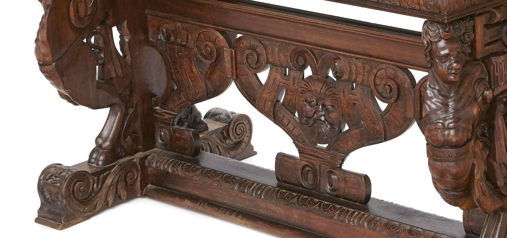 This fabulous 19th century Continental Renaissance style finely carved walnut library table featuring a floral and figural motif with ornate stretcher.
Measures: H. 32 inches x W. 52 inches x D. 30 inches.
Keywords: Center table, entry hall table.