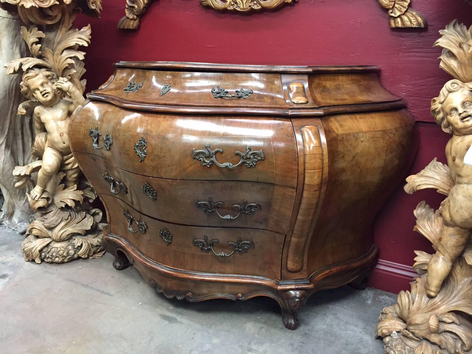 Fabulous large 19th century Italian Rococo style walnut and olivewood veneered Bombe Commode with four drawers and beautiful bronze handles on cabriole legs. Very desirable and elegant proportion.
Measures: Height 36 inches x width 54 inches x