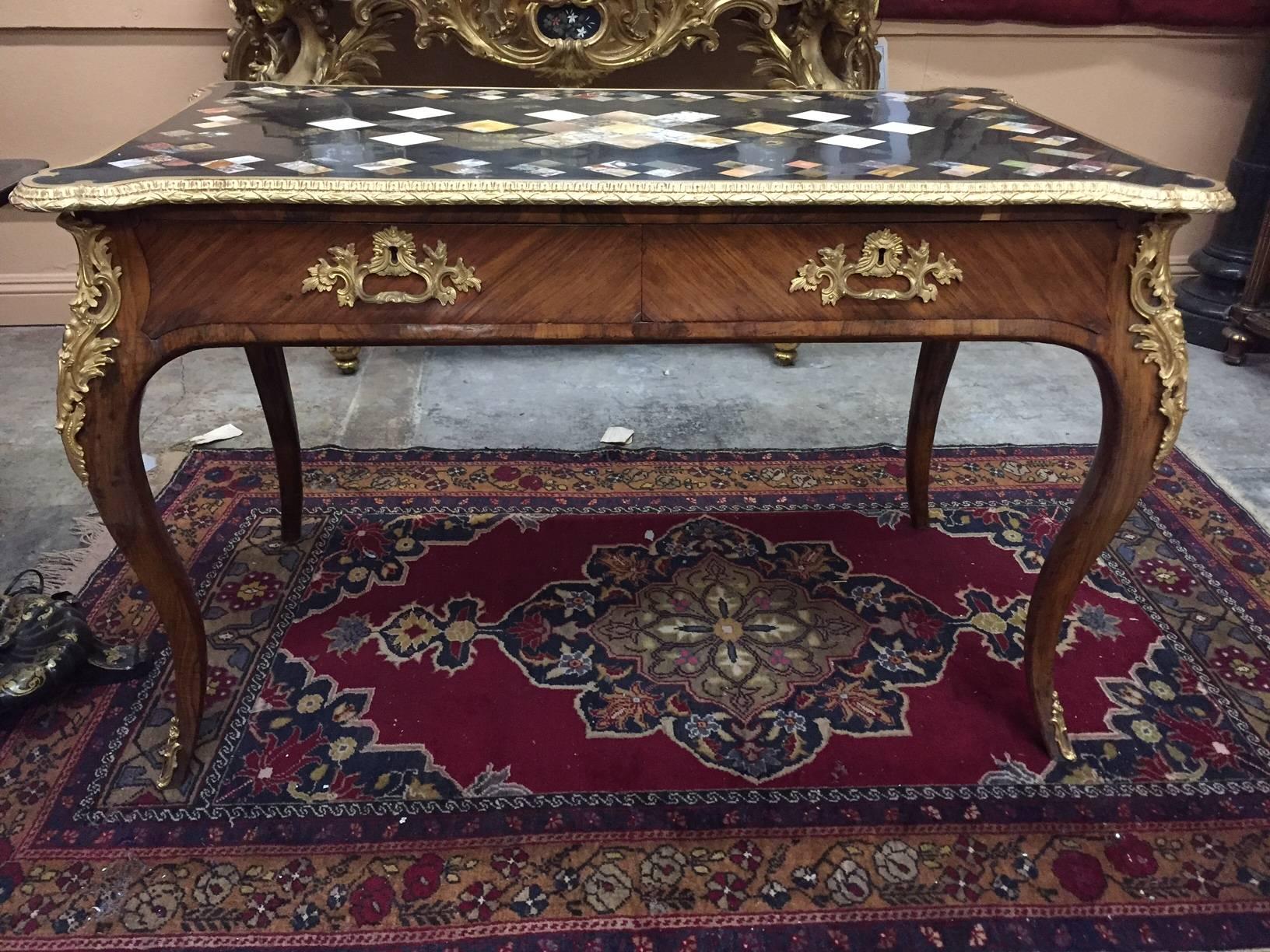 Exquisite 19th century French Louis XV style ormolu-mounted kingwood bureau plat. The impressive marble inlaid top decorated with various pieces of exotic marble inset within a fine ormolu frame over two kingwood drawers all on four cabriole legs