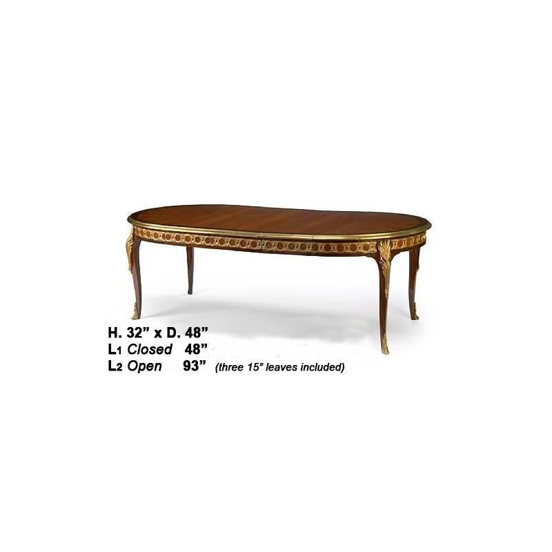 Attractive Louis XV style gilt bronze-mounted walnut extension dining table, mid-20th century. The beautiful kingwood veneered top with gilt bronze trim on a frieze filled with fine ormolu work resting on four cabriole legs mounted with ormolu