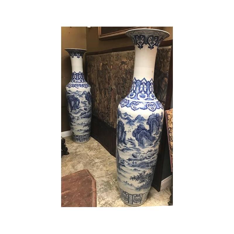 Impressive and massive pair of signed Chinese blue and white porcelain palace vases intricately and freely hand-painted with a rich and deep blue color each with a different natural landscape scene. 

Measures: Height 73 inches.

 