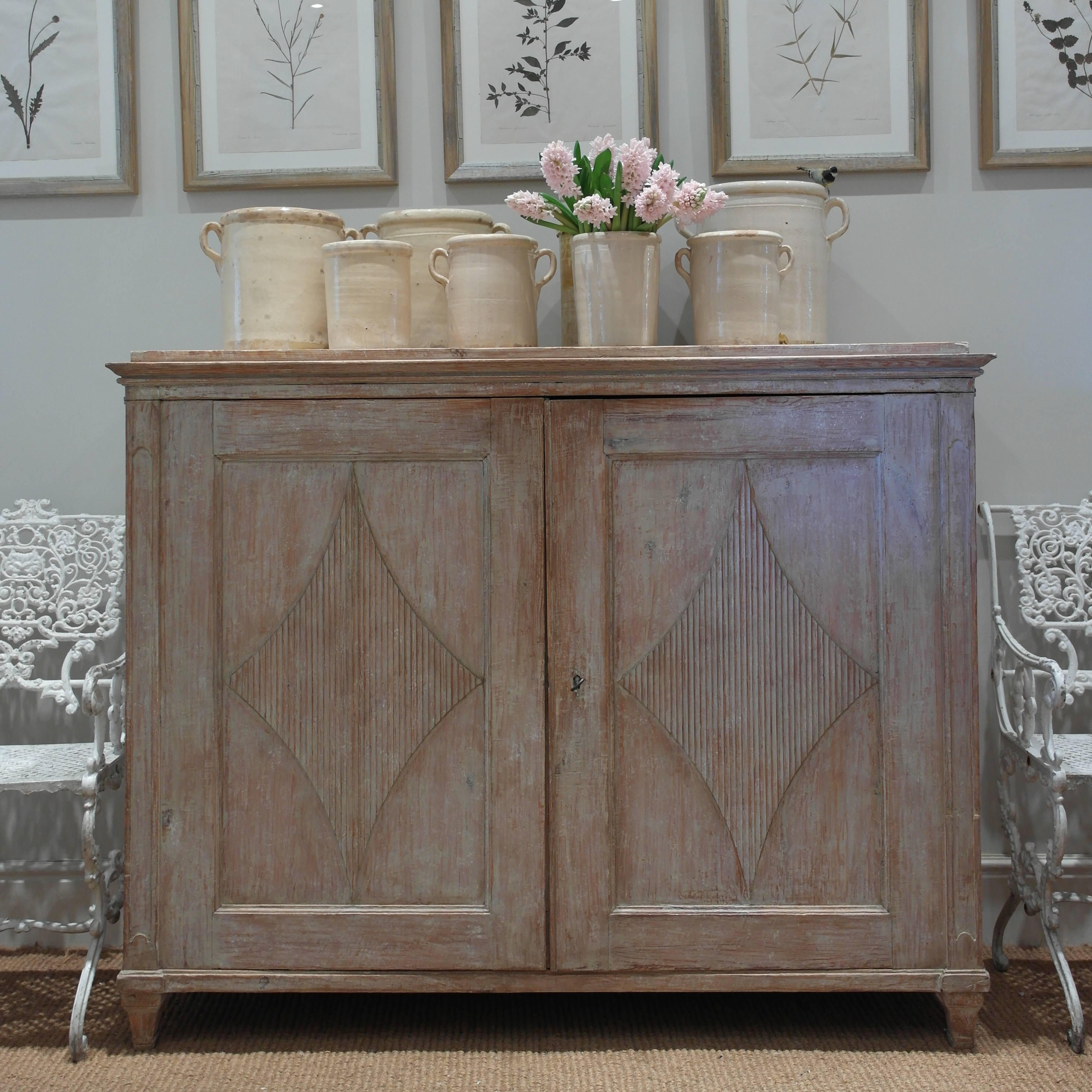 An early 19th century Swedish buffet - a beautiful example in original pinky beige original paint (lightly retouched) nice proportions and in good condition with carved wood reeded detail doors with working key and a shelved interior.