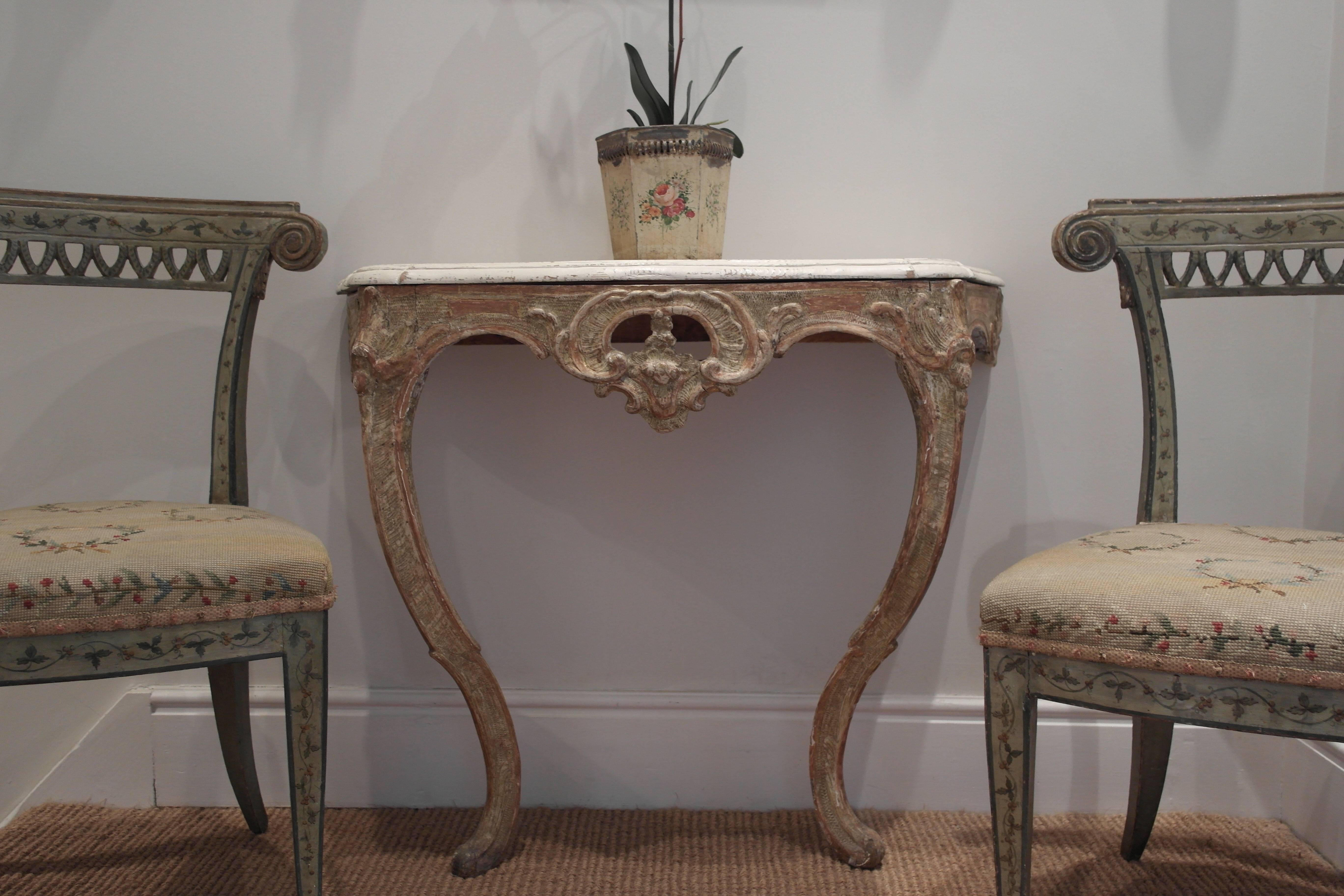 A small charming late 18th century Swedish console table with the fine hand-carved detail in original lightly gilded paint and in good condition. The original top has been repainted.