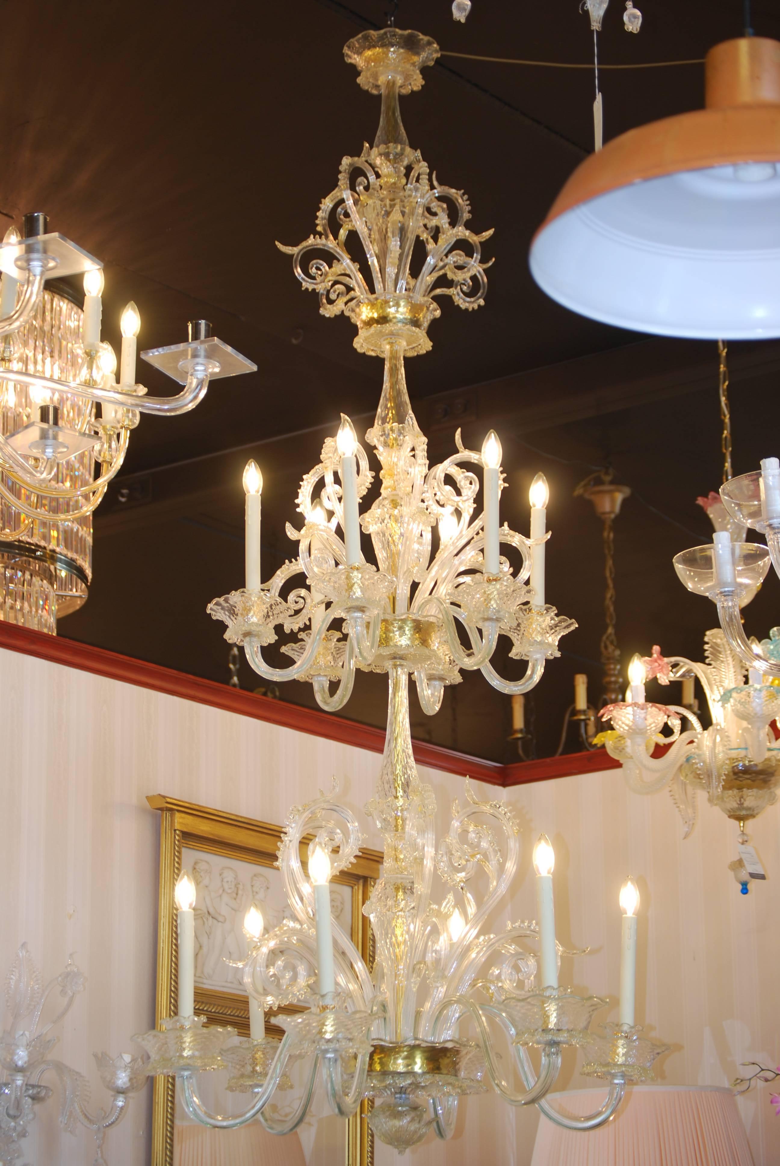 These two identical slim Murano chandeliers with gold decoration from the K.N.A.W.  also known as the Trippenhuis building in Amsterdam. They were hanging in the library.
The two 12 lights chandeliers are in excellent condition and recently restored