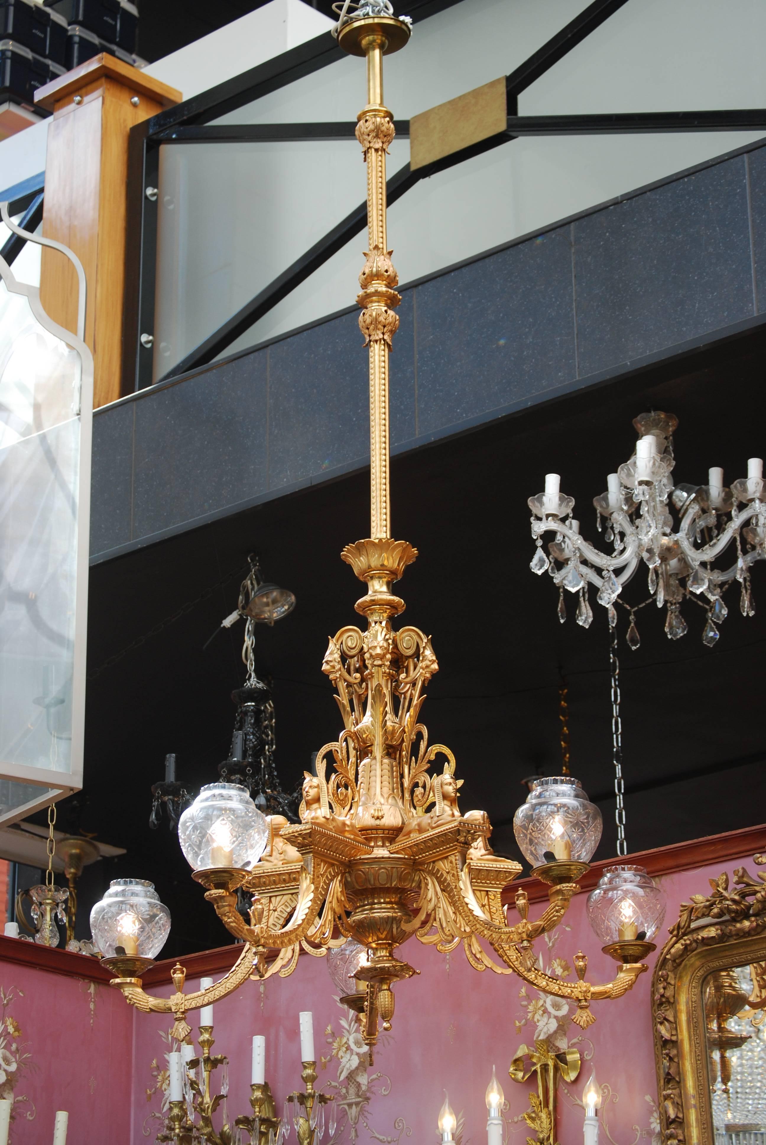 This extremely rare Empire style ormolu five lights gas chandelier has five sphinxes on top of the arms.
The Egyptian ornaments are well represented.
On the top base there has been an inscription from the designer, see photo.
ThIs chandelier is