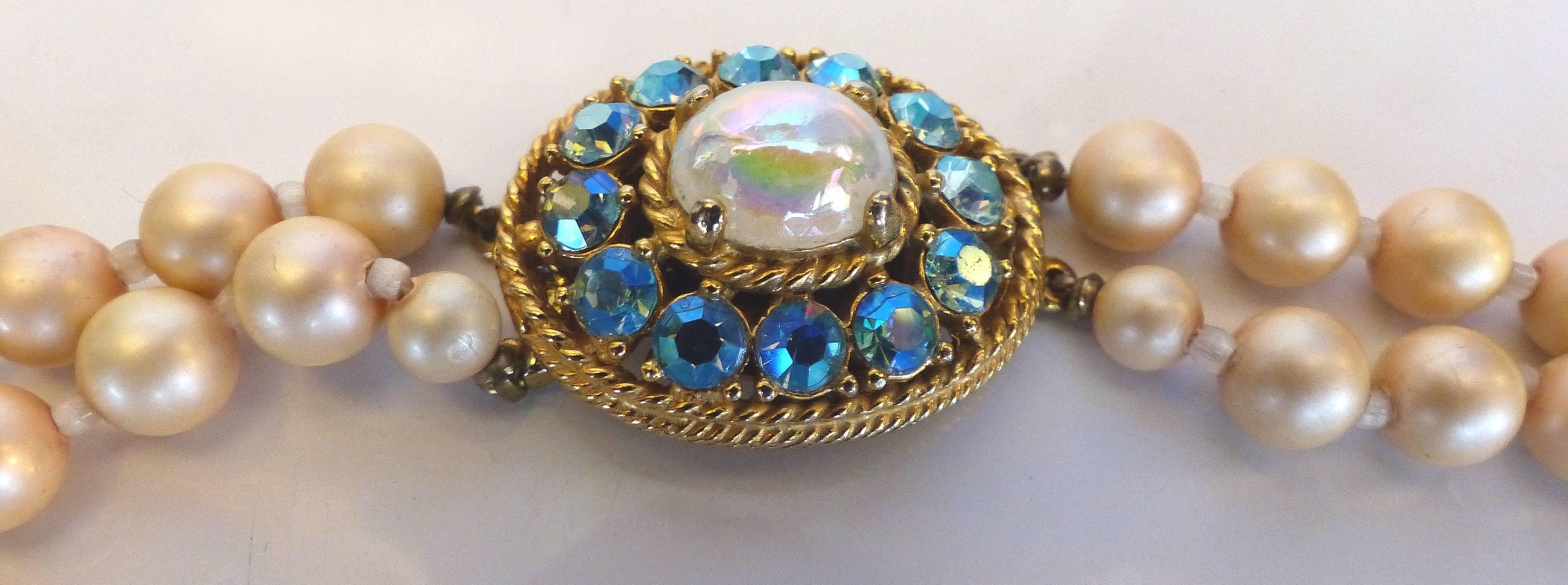 Elsa Schiaparelli graduated faux pearl double strand necklace with blue Aurora and rhinestone clasp.