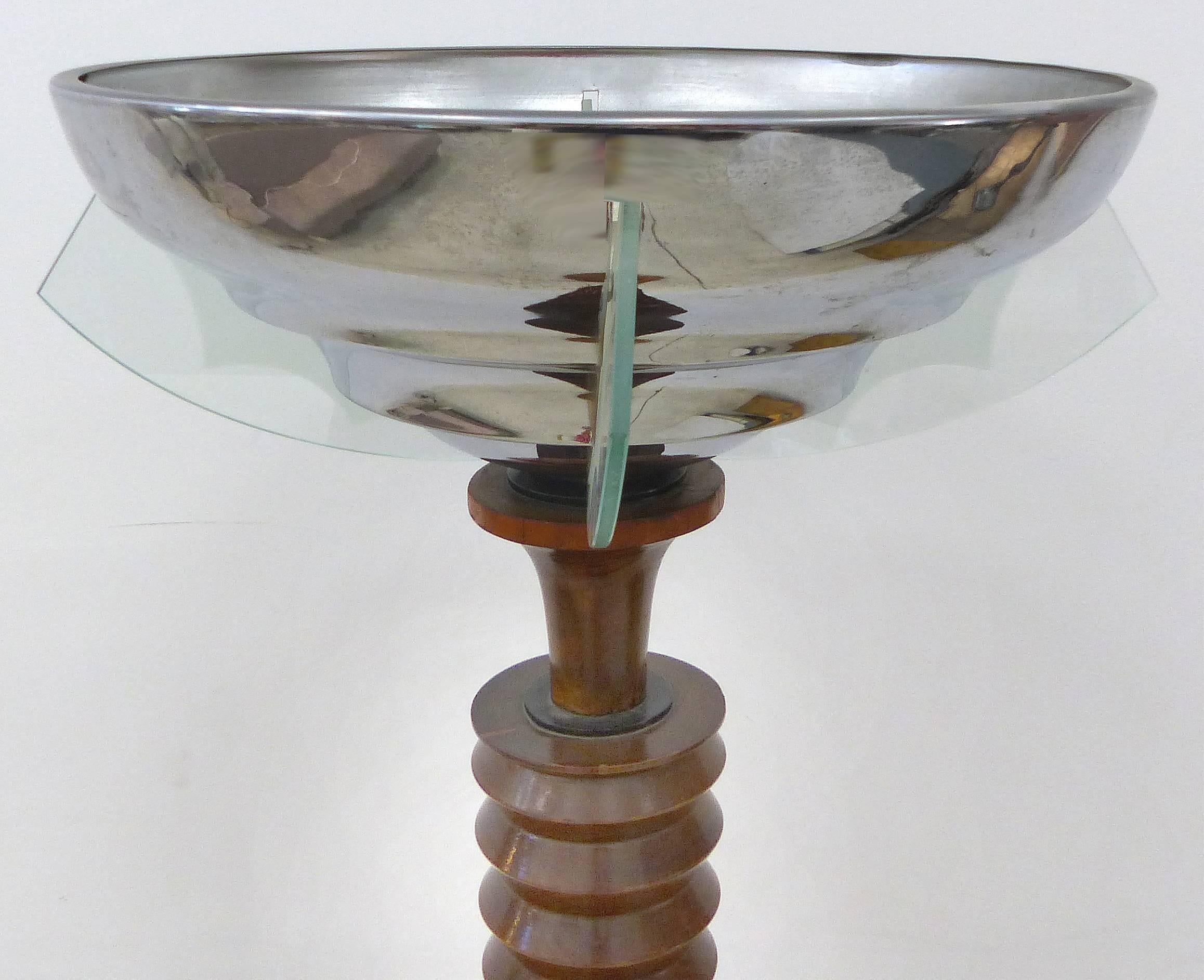 French Art Deco Atelier Petitot Torchiere with Chrome and Glass Fins

This Classic French Art Deco torchiere by Atelier Petitot is from the 1930s. The wood shaft swells as it rises to meet ten graduated rings. The illuminated glass fins are frosted