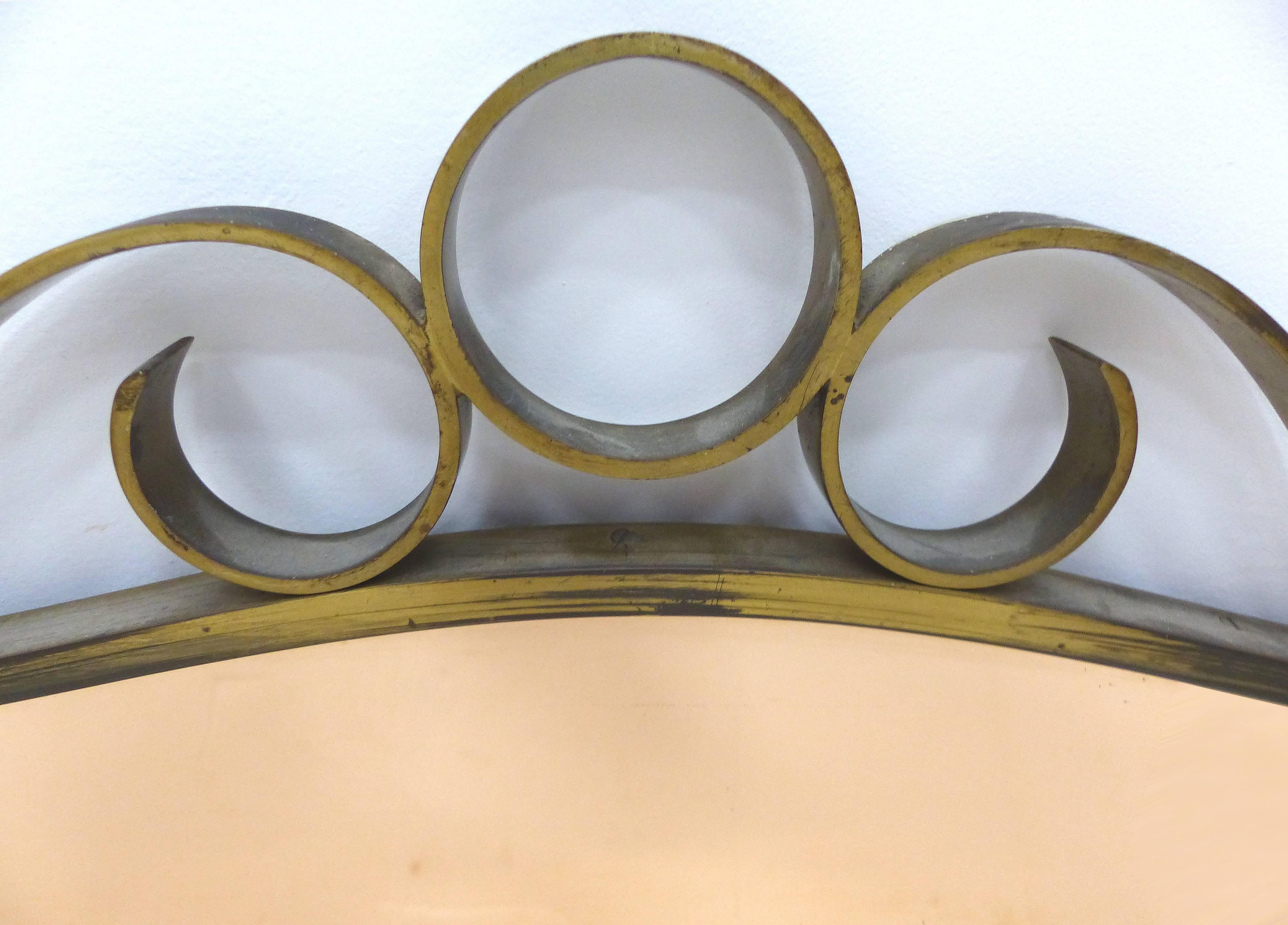 Art Deco Brass Peach Glass Wall Mirror

A gently curved brass Art Deco wall mirror with the original peach glass mirror. The brass has achieved a bronze-tone patina.
  
 