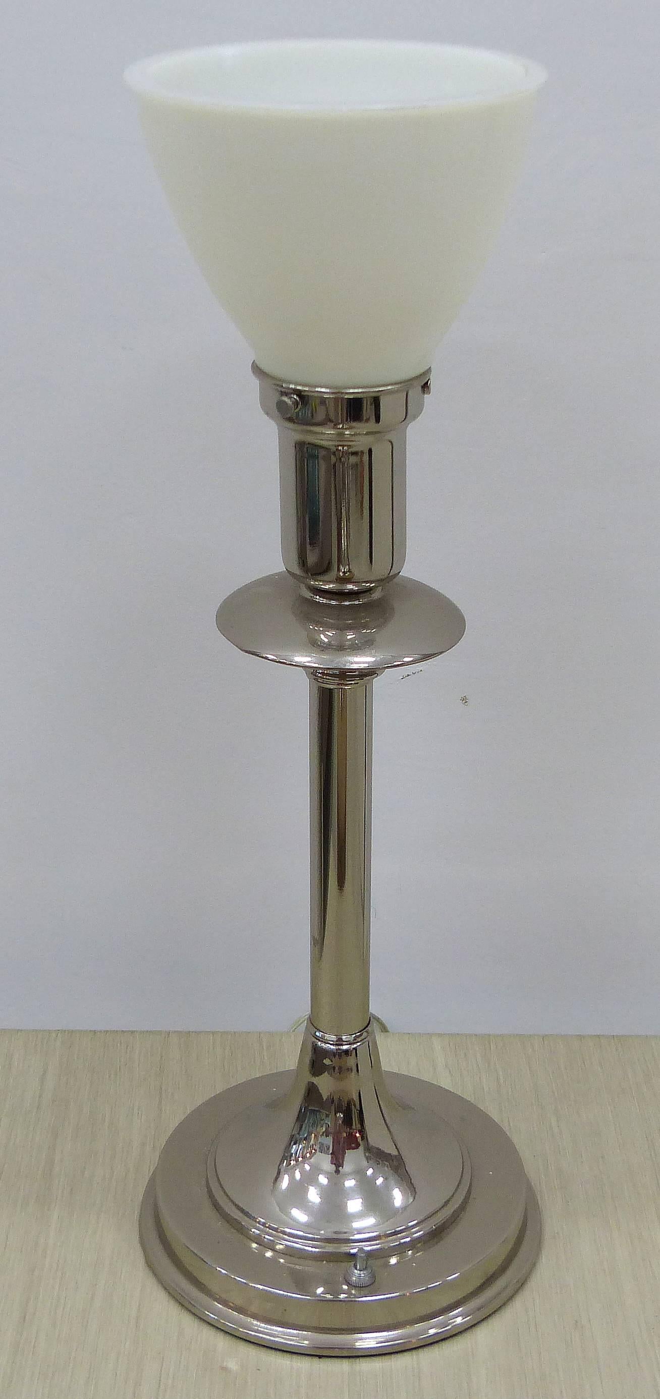 American Art Deco Markel Table or Desk Lamp

This large American Art Deco table lamp was made by the Markel Company of Buffalo, New York in the 1930s. The lamp, in brilliant nickel, has a stepped base, speed disks in the central shaft and a double