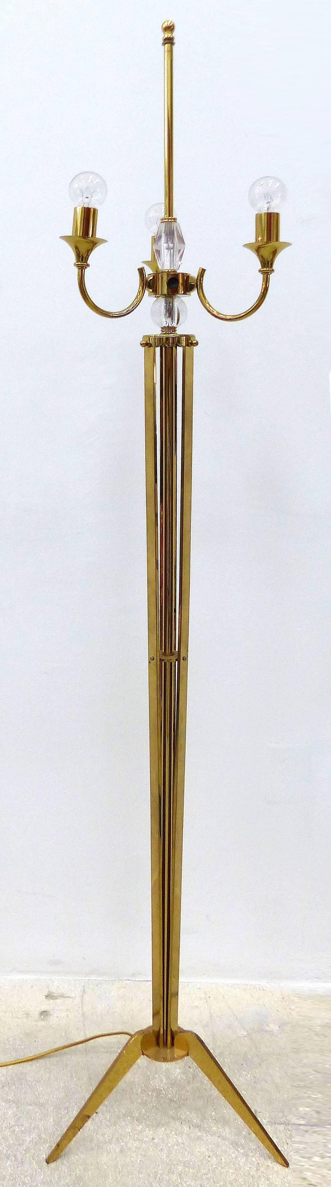 1940s French Brass and Crystal Floor Lamp

A very elegant French Art Deco floor lamp is from the 1940's. Highly polished brass and gleaming crystal make a statement for any home. The lamp sits on a tripod base with a central shaft flanked by three