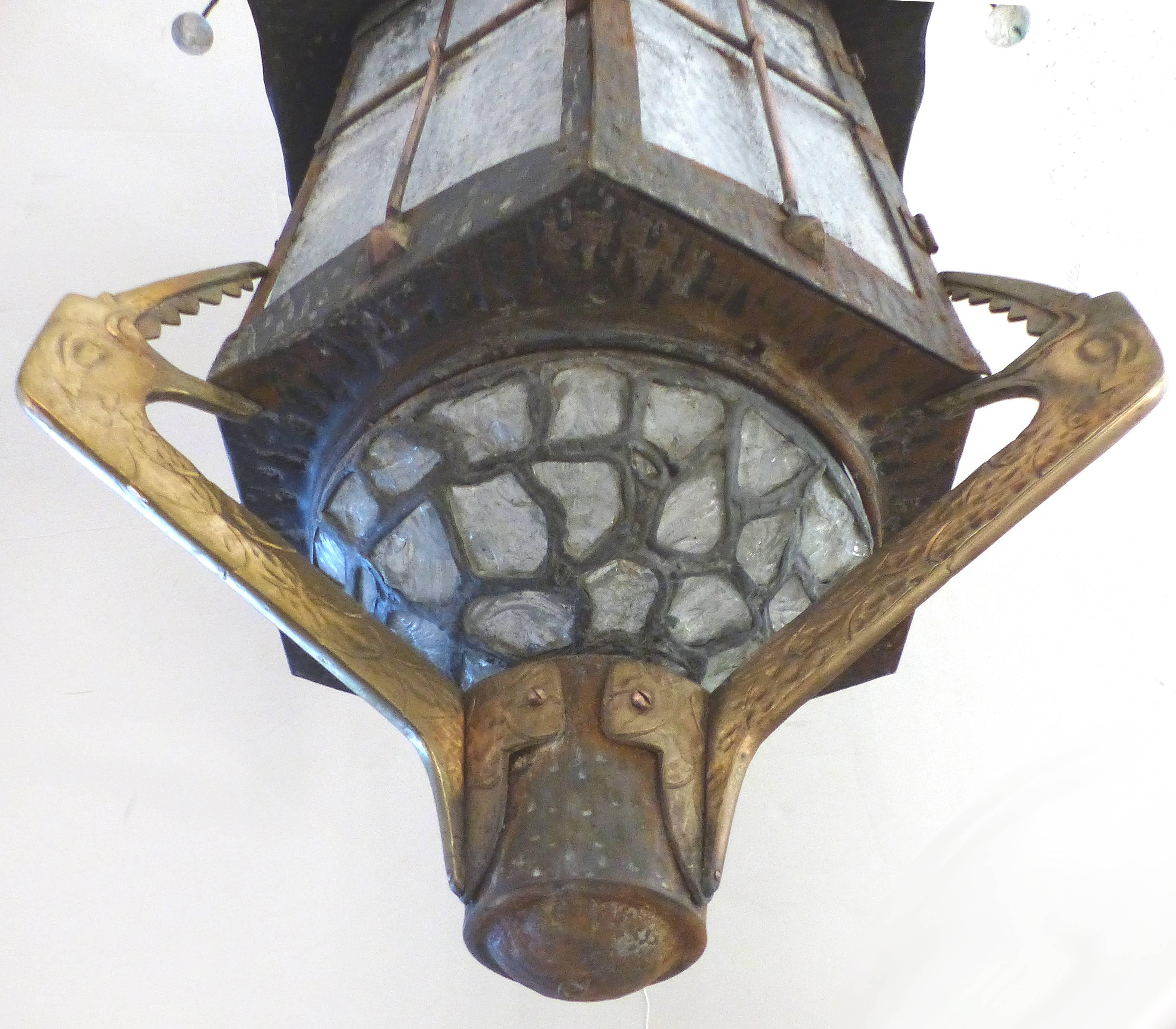 A vintage handmade mixed metals lantern created in an Asian motif. The hexagonal lantern has a hidden door for access and is glazed in frosted rippled glass. Each panel is guarded by crossed copper bars. The lantern top is vented and glass drops are