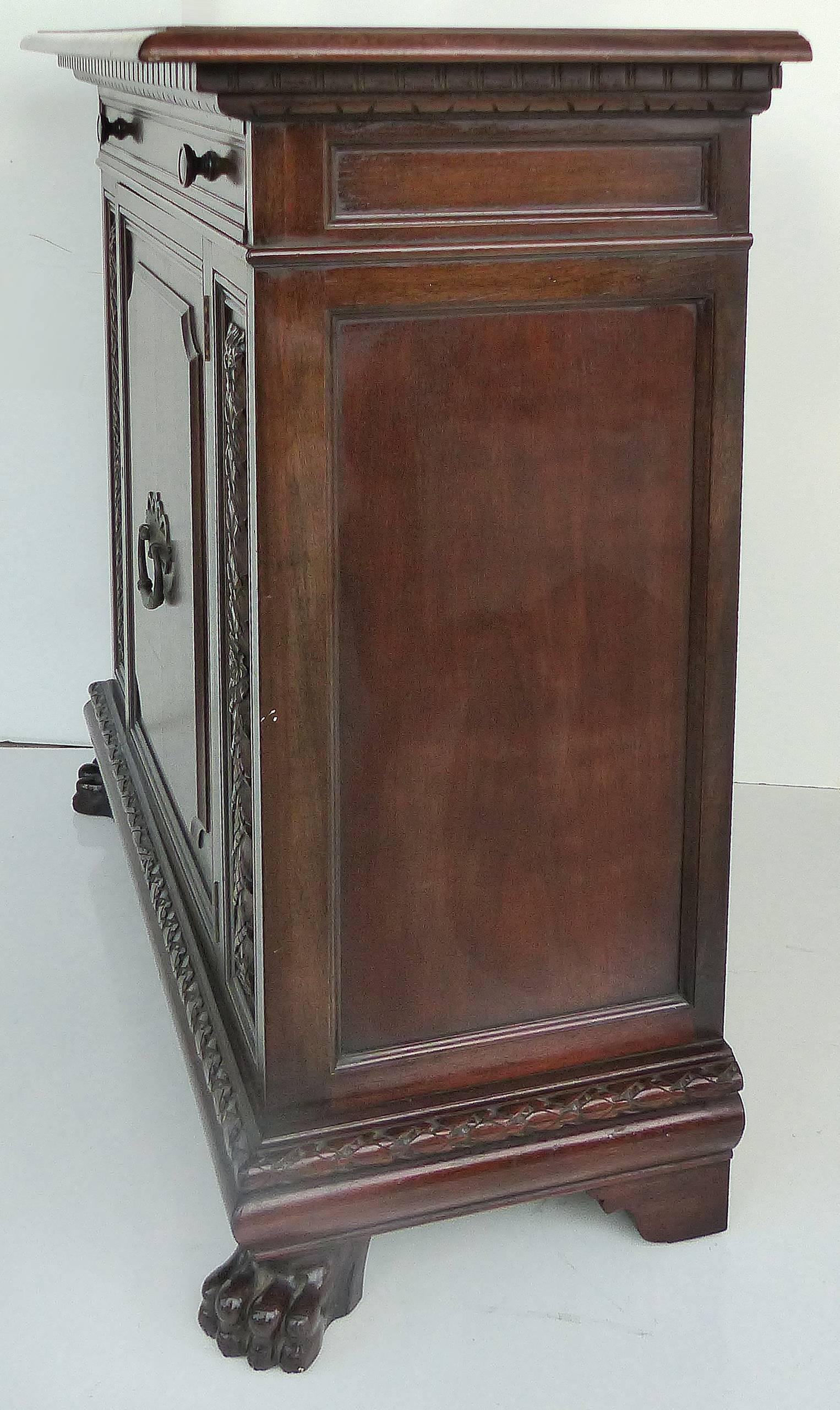 1930 S. Pagano carved lion paw traditional cabinet

An fine quality single door cabinet with large carved lion's paw feet by the cabinetmaker S. Pagano. The cabinet has a single slender drawer above the single door below. That door reveals ample