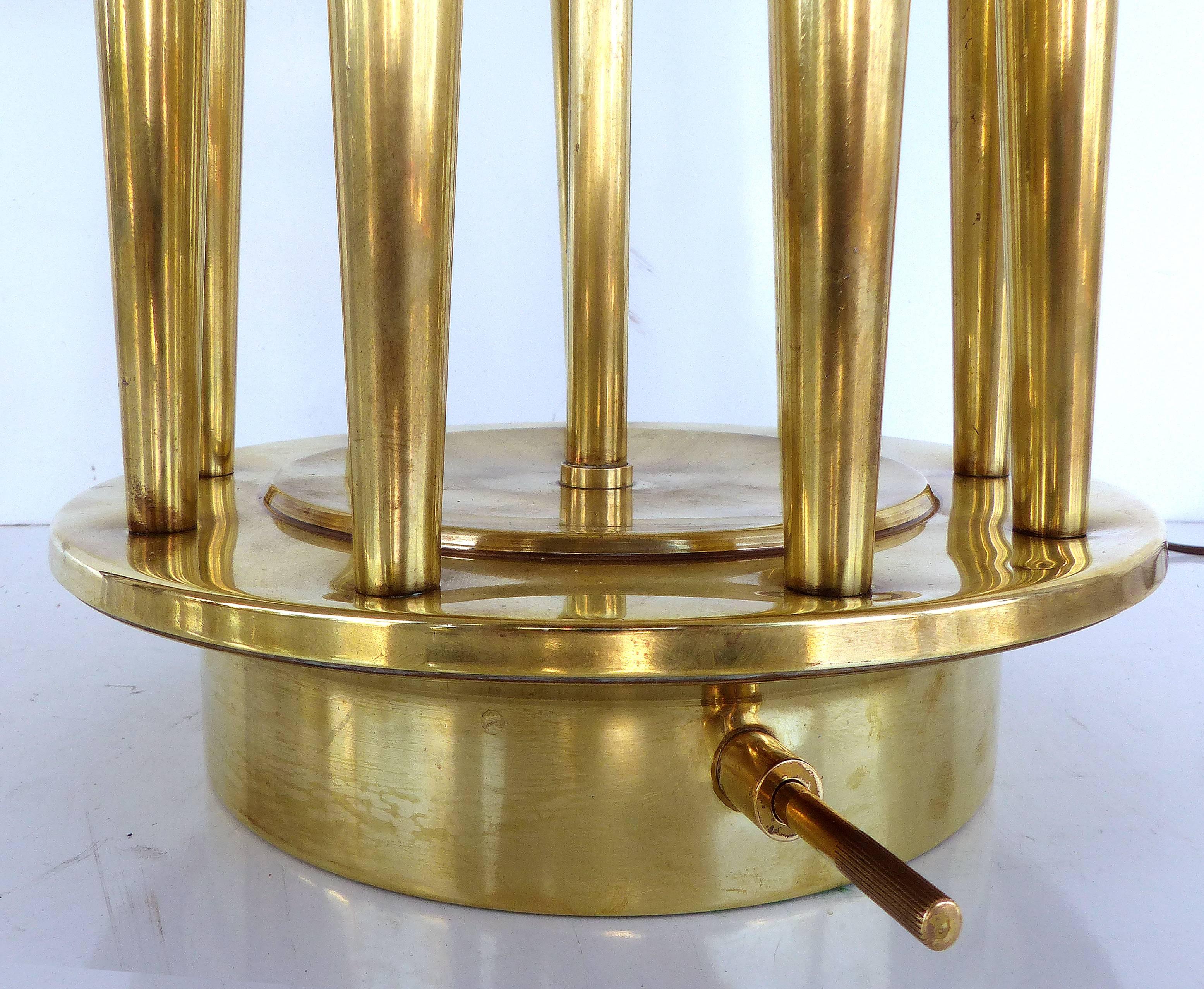  Tommi Parzinger Stiffel Mid-Century Table Lamp

A monumental Mid-Century Modern brass table by Tommi Parzinger for Stiffel. The brass base has nine bass candleholders that rise to hold candelabra bulbs that illuminate at the bottom of the shade.