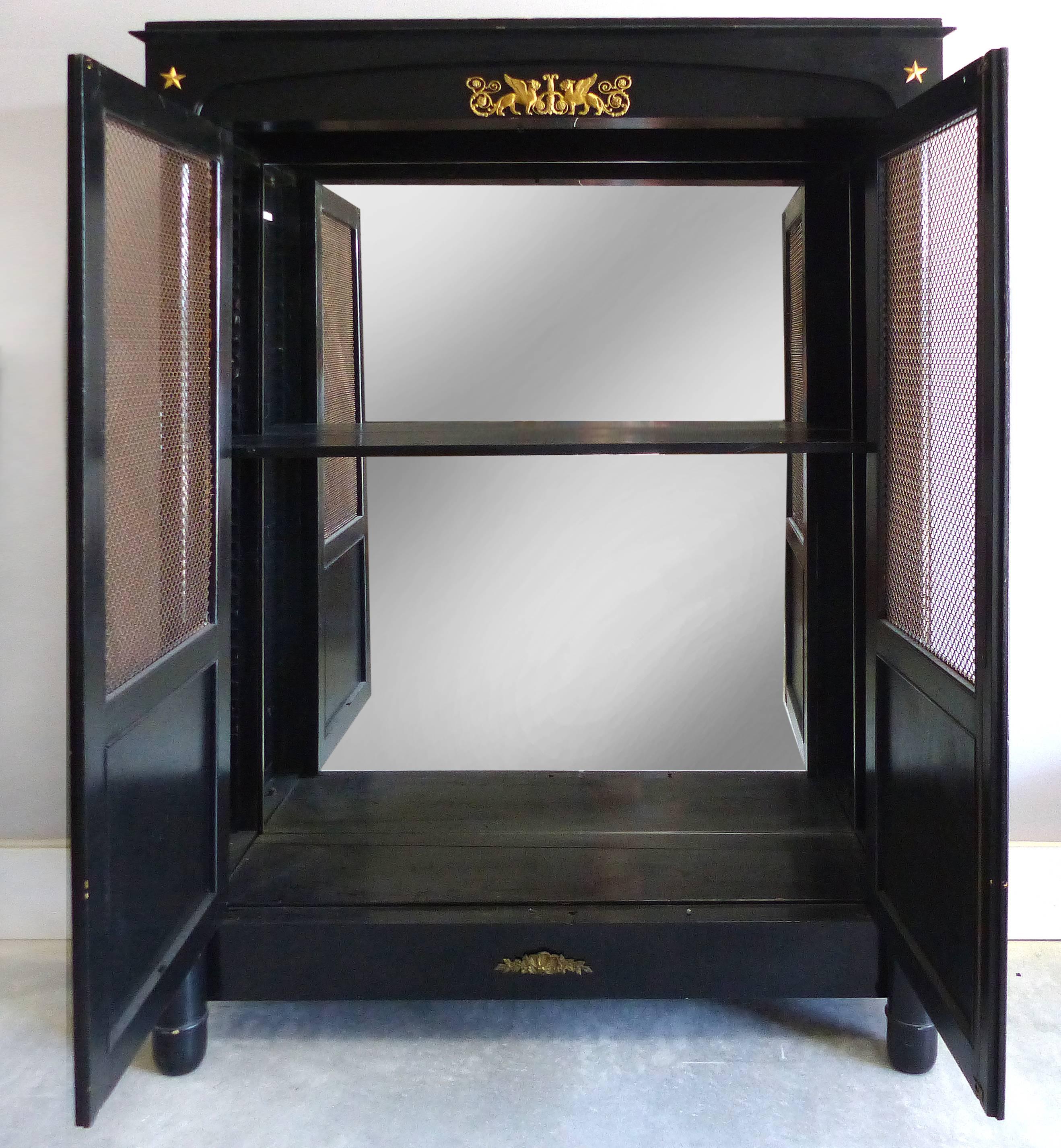 French Empire Lacquered Bibliotheque with Bronze Trellis Doors and Ormolu

Offered is a fine quality lacquered 19th century, French Empire Bibliotheque bookcase with bronze trellis work doors and finely chased bronze ormolu mounts. The mounts depict