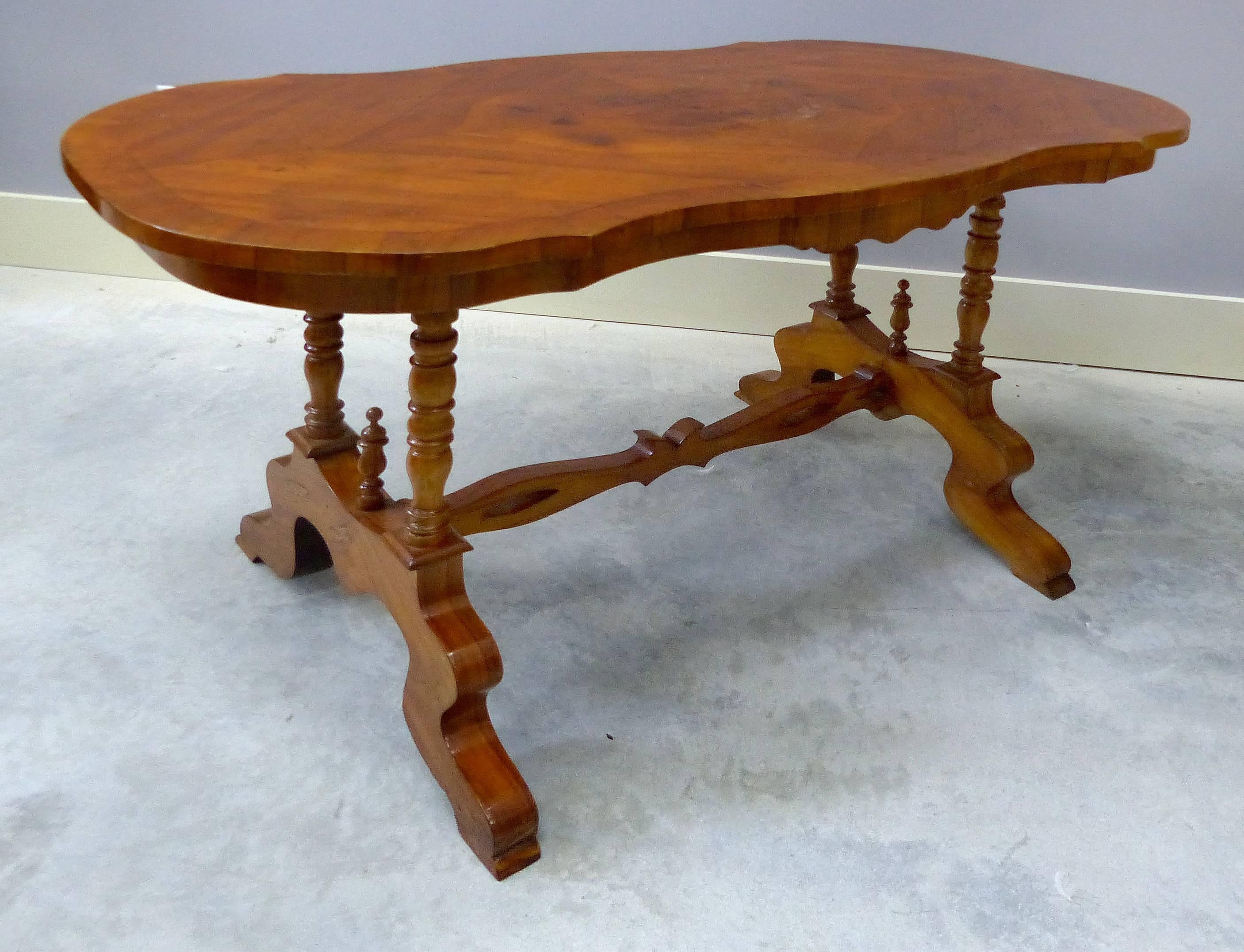 19th Century Austrian Biedermeier Centre Table

This is an Austrian 19th century Biedermeier scalloped rectangular centre table having finely turned legs which support a matched grain veneer top with banding. The centre stretcher is carved out and