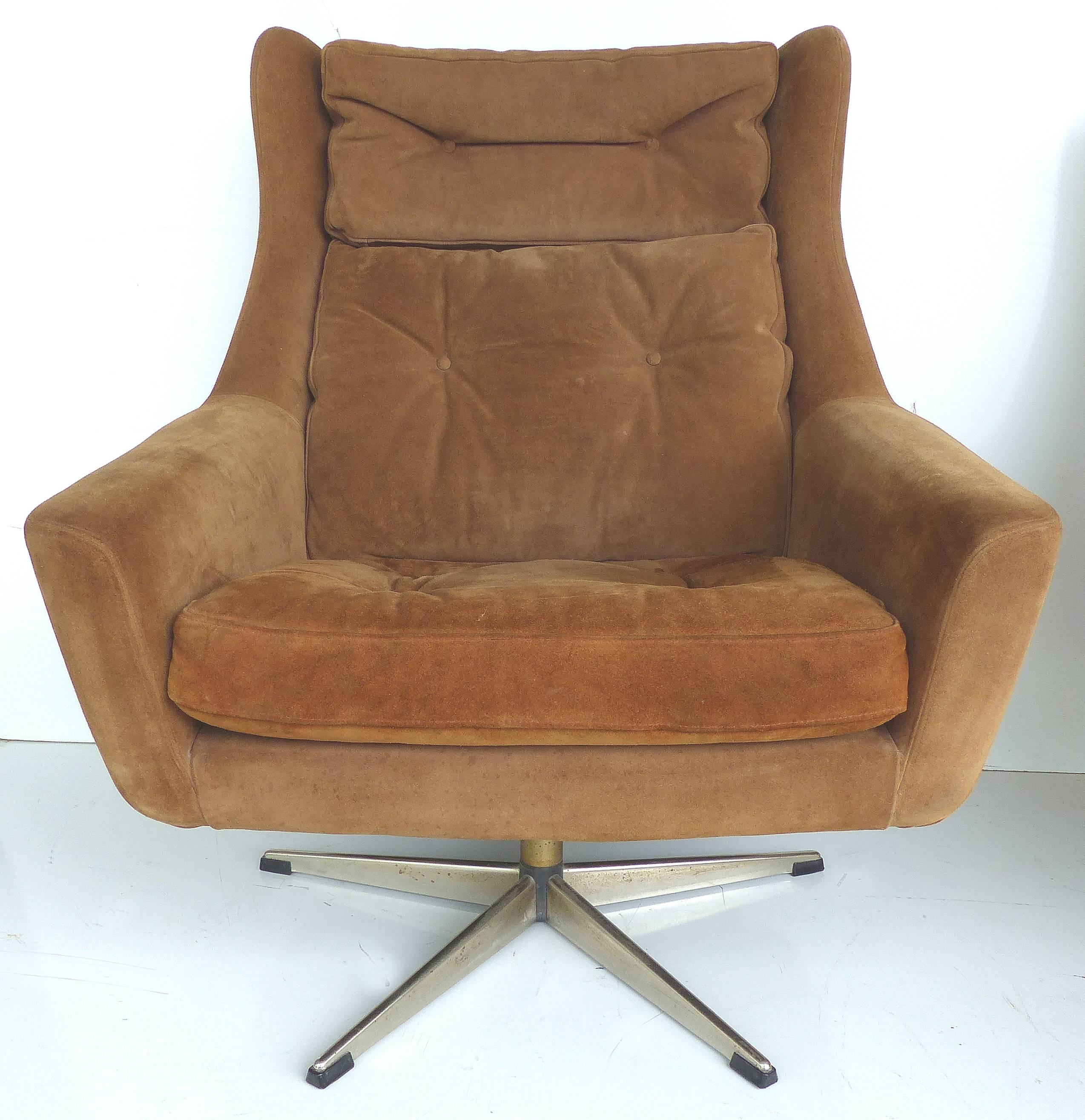Offered is a of Danish Mid-Century Modern swivel lounge chair in suede imported by John Stuart that has an accompanying ottoman. The chair is large-scale and quite comfortable. Both pieces are supported by chrome pedestal bases with rubber feet.
