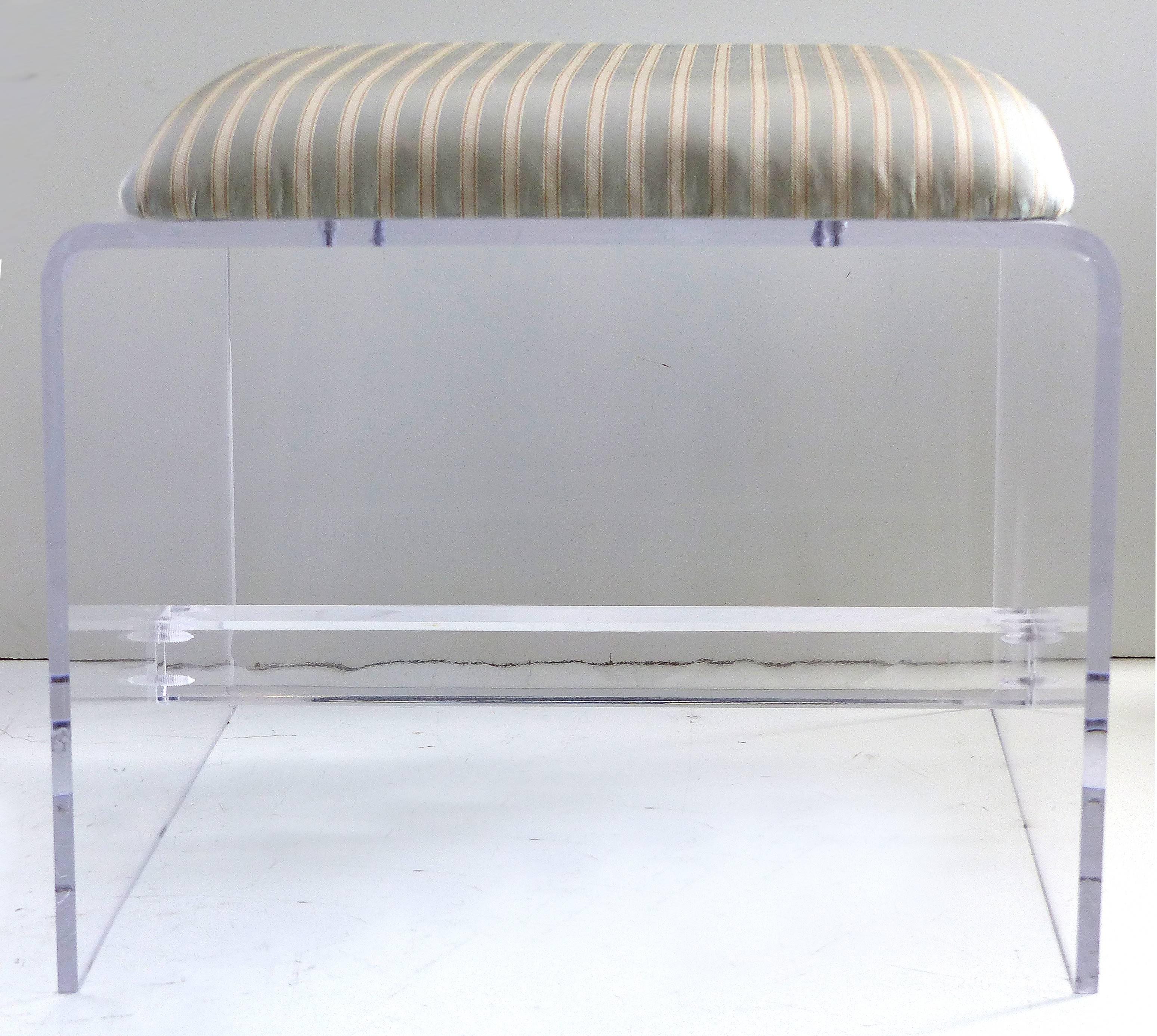 Offered is a custom-made Lucite waterfall style bench with an upholstered seat cushion and a Lucite stretcher.