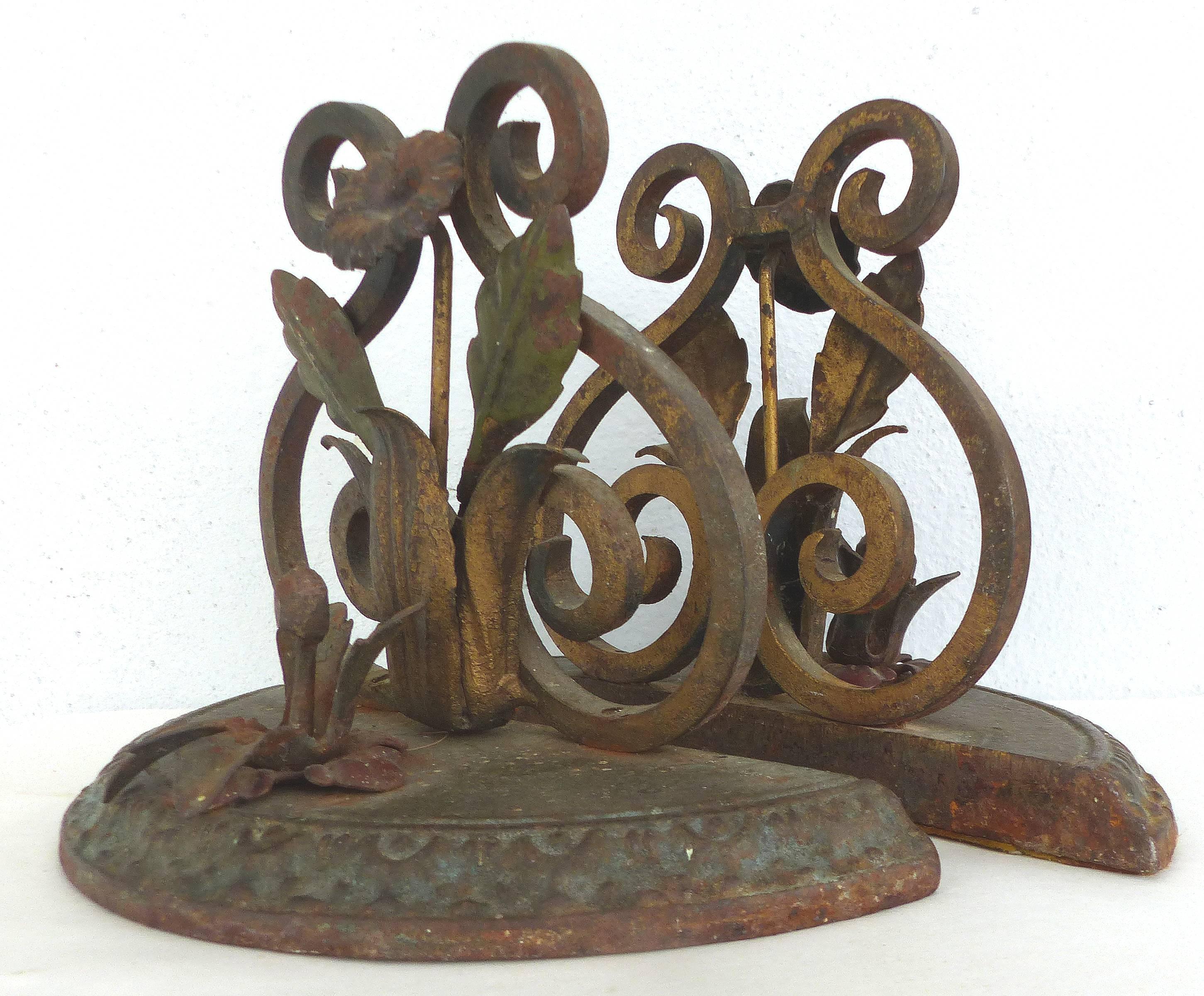 Offered is a pair of ornate 1920s Art Deco iron bookends with remnants of the original gilt and polychrome finish. Acquired from the prominent Coconut Grove estate of the Lily pharmaceutical family. The designer of this home, Paul Chaflin, designed