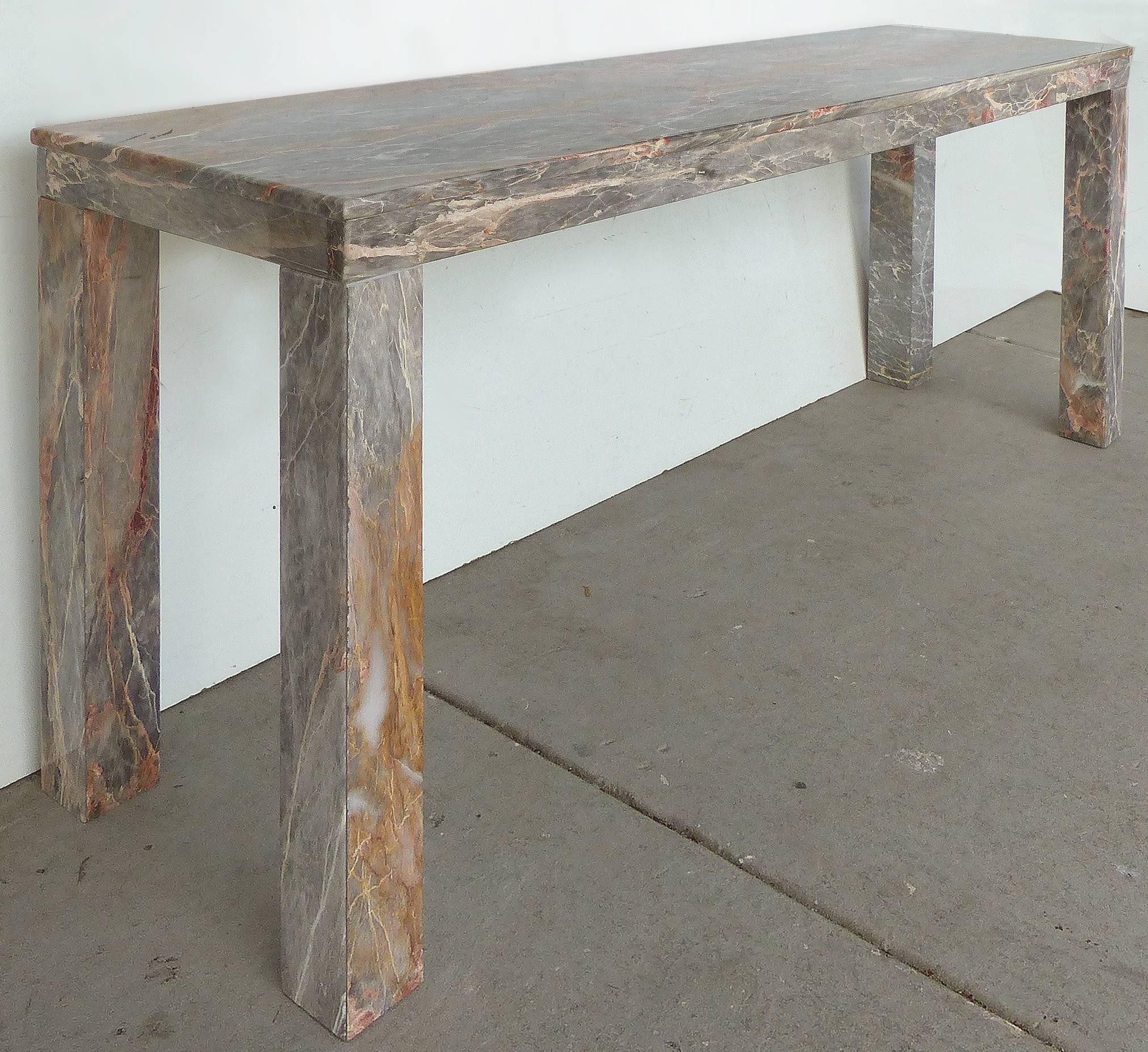 Offered is a sleek custom-made parson's table or console made of a solid slab of beautifully grained multicolored marble.