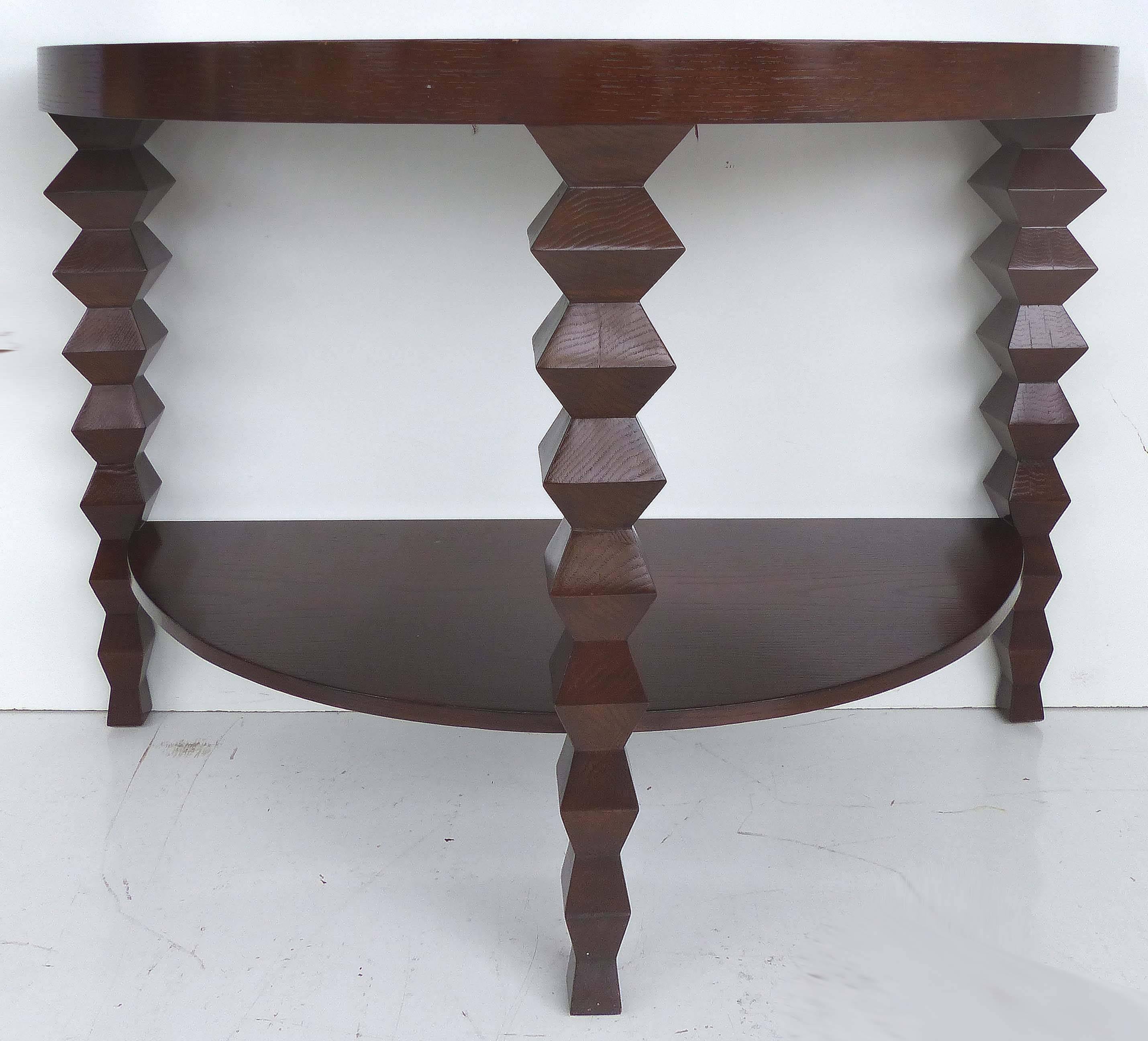 Offered for sale is a Donghia demilune console table from the Donghia "Zig-Zag" Collection with three sculptural legs and a lower tier. This console is a recent acquisition from an affluent Miami Beach condo. This is a rare and sought