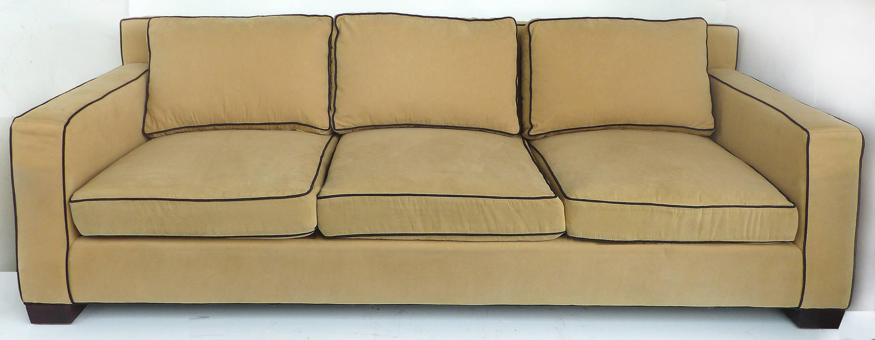 Offered for sale is the Ralph Lauren Graham Sofa. With its Classic lines and upholstered in ultra fine velvet in colorway camel color with black contrast piping (65% polyester and 35% cotton). Features 100% down filled seat cushions and back