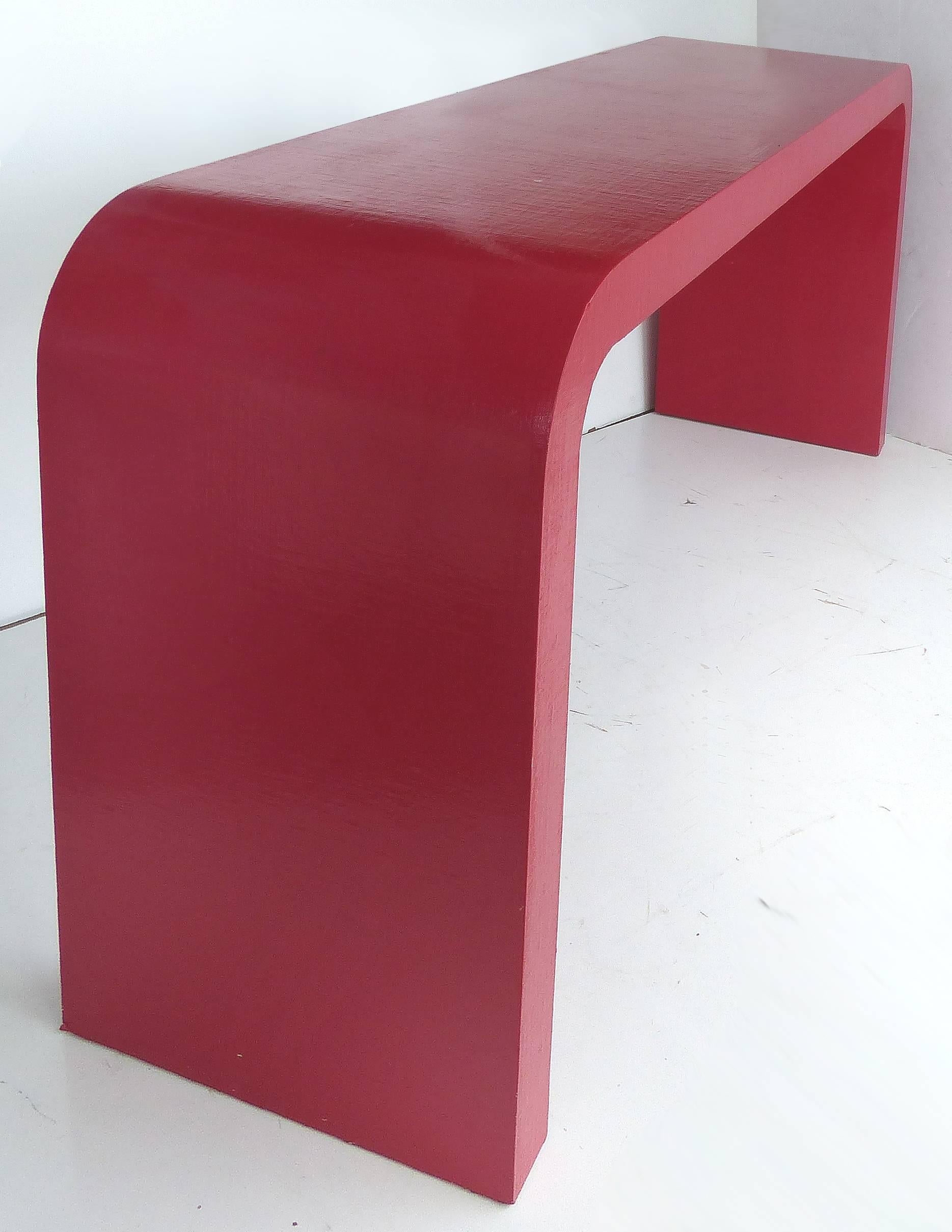 Offered for sale is an Karl Springer style linen clad waterfall console table in a fire engine red lacquer finish. Has some flakes to finish but could be painted or touched up at buyer's discretion.