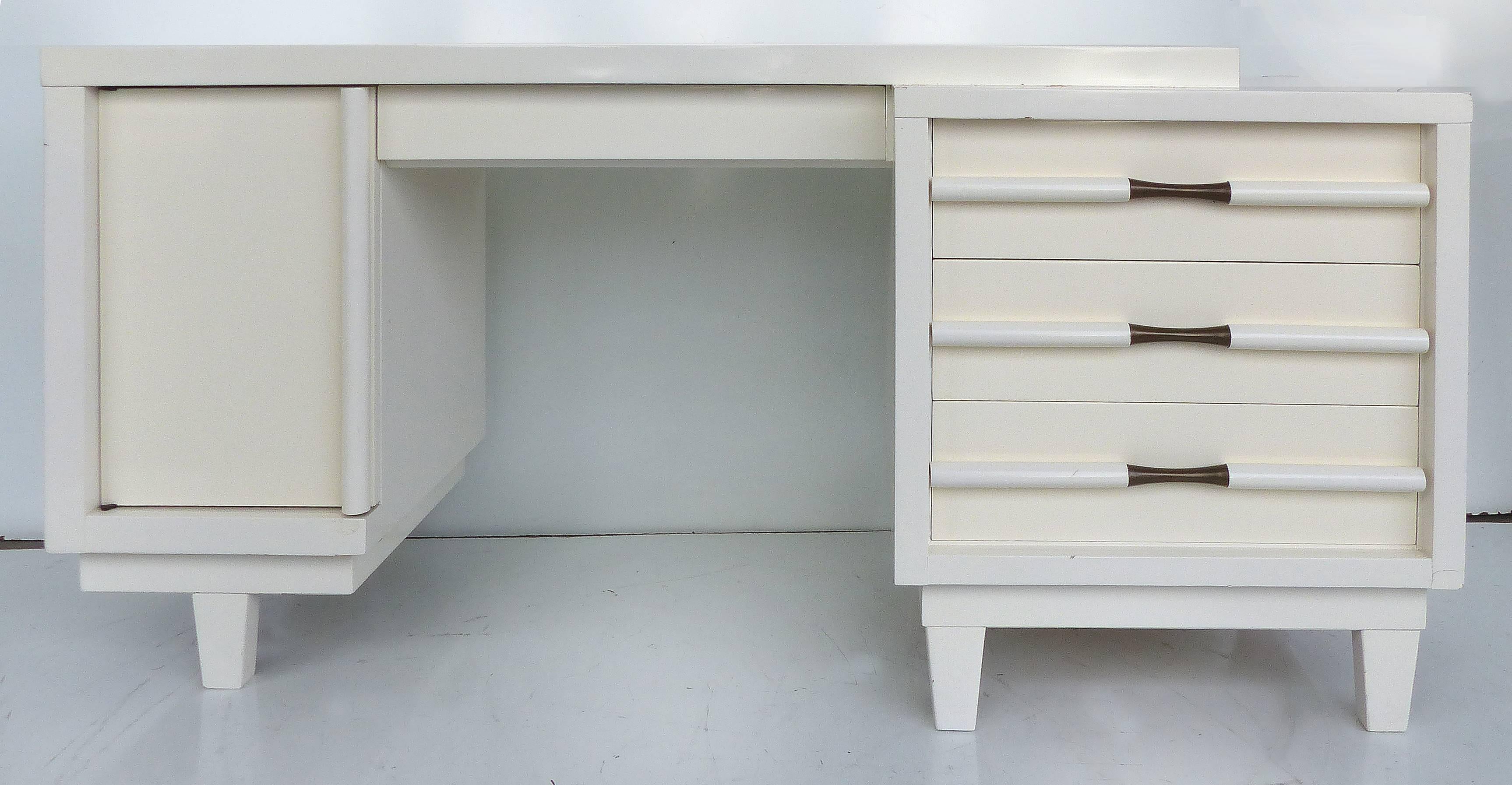 Offered for sale is a vintage Mid-Century Modern desk recently acquired from a multi-million dollar South Beach condo that was designed by a prominent South Florida designer. Unmarked but reminiscent of the designs of Paul Laszlo. Wonderful hardware