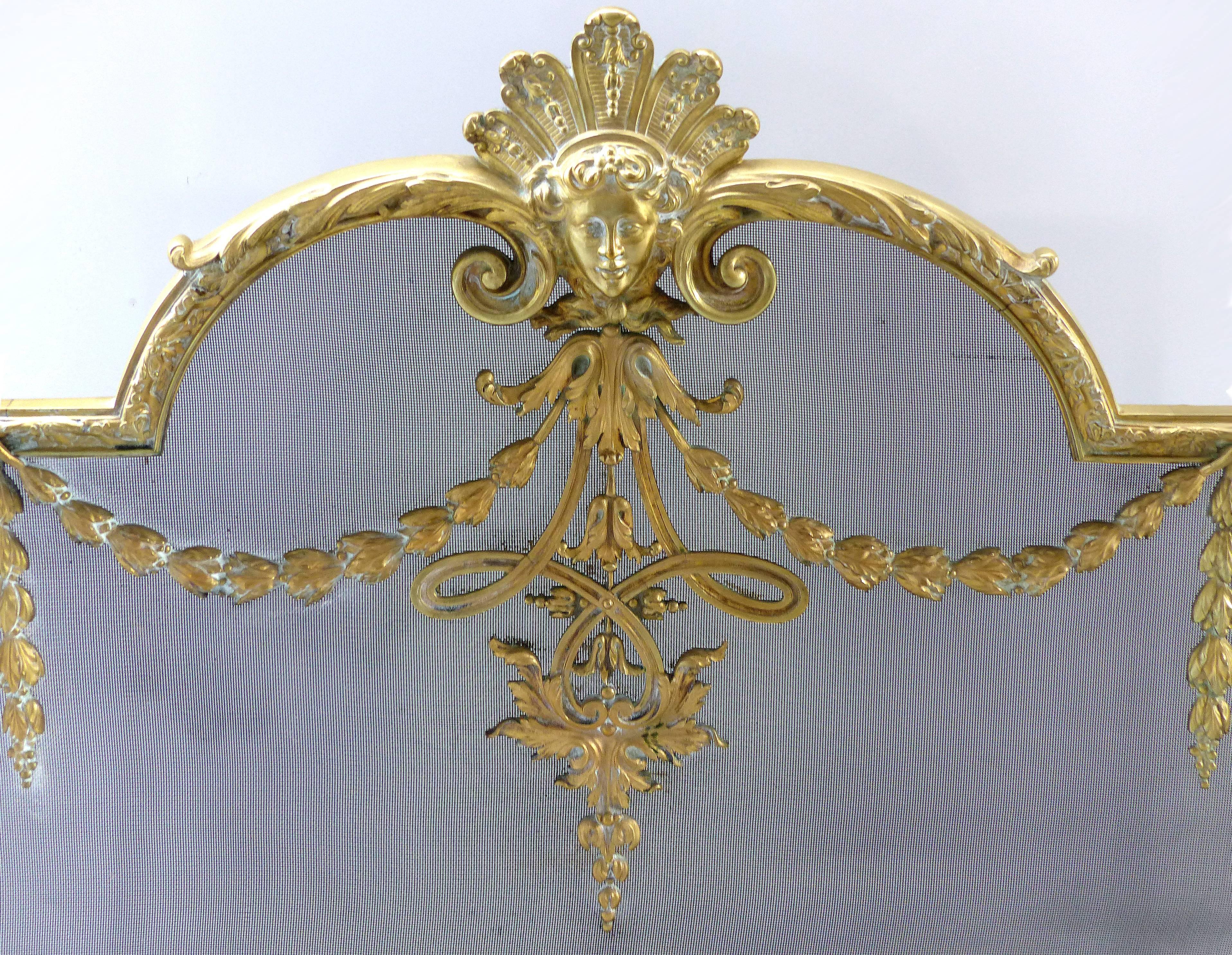 Offered for sale is a lovely brass firescreen acquired in Paris from the 1920s. The frame has a subtle patina and the removable screen is in excellent condition. Early ornate Art Deco design patterns surround the frame with a finely cast female