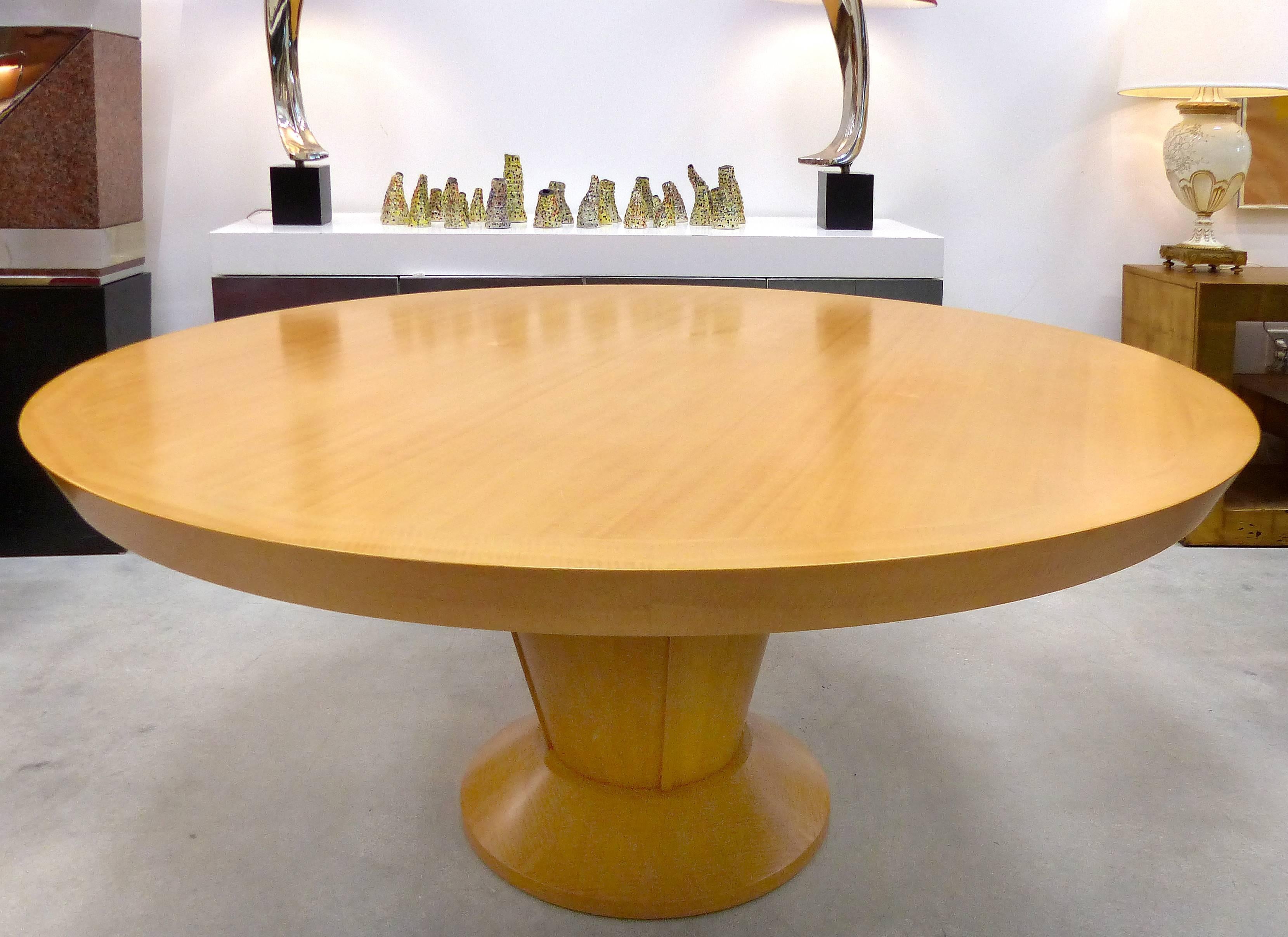 Offered for sale is a sleek large round single pedestal dining table of matched grain blond maple attributed to Dakota Jackson. Unsigned but marked with impressed model numbers. This could be installed as a conference table.