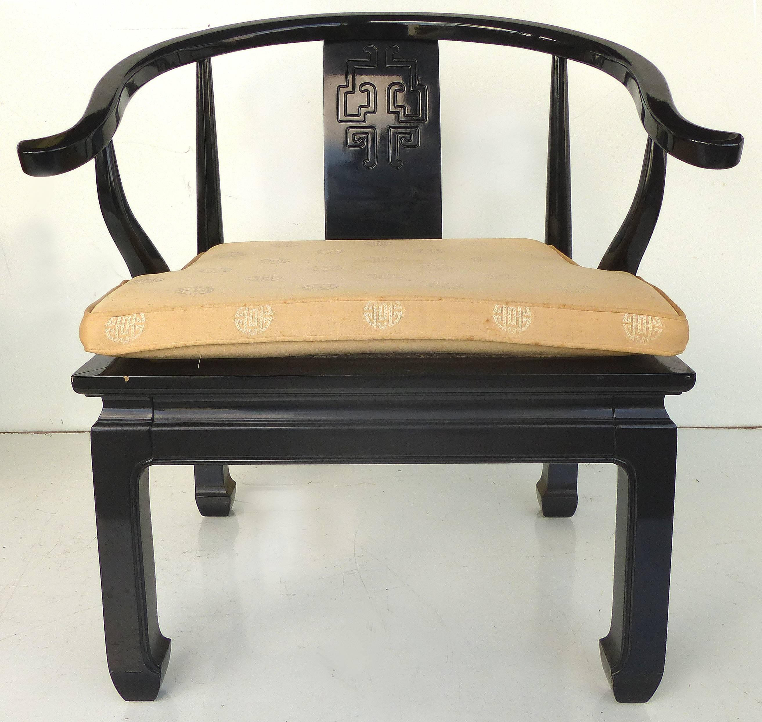 Offered for sale are a pair of James Mont Asian Style lacquered arm chairs from Century Furniture. The arms gracefully rise to the incised backslate. The seats retain the original Asian medallion upholstery with loose cushions which do show age wear