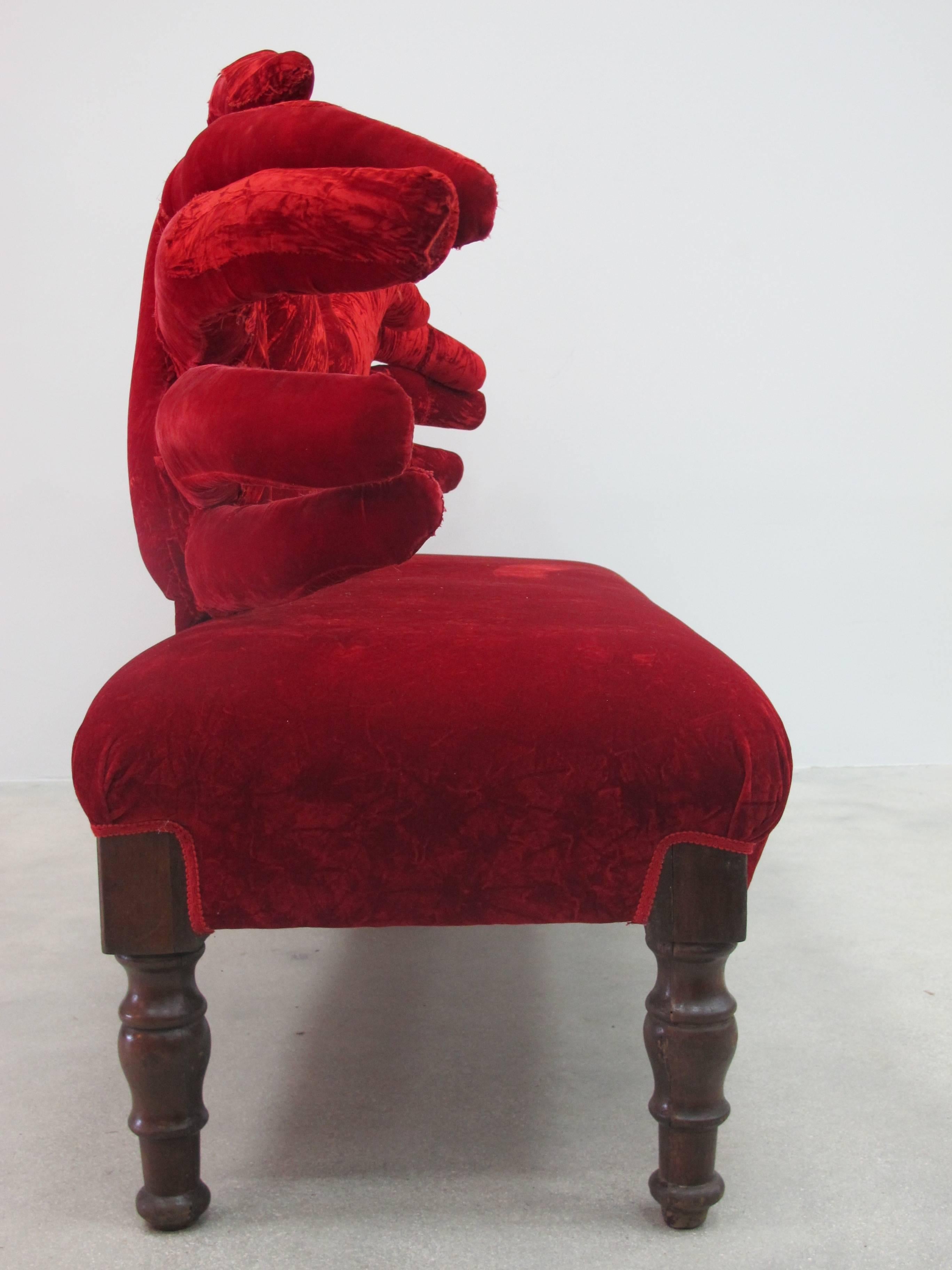 Two handed sofa by the Italian designer Carla Tolomeo (b. 1945) made in the early 1990s in red velvet with large hands as the back rest. The piece is signed on the leg.

 